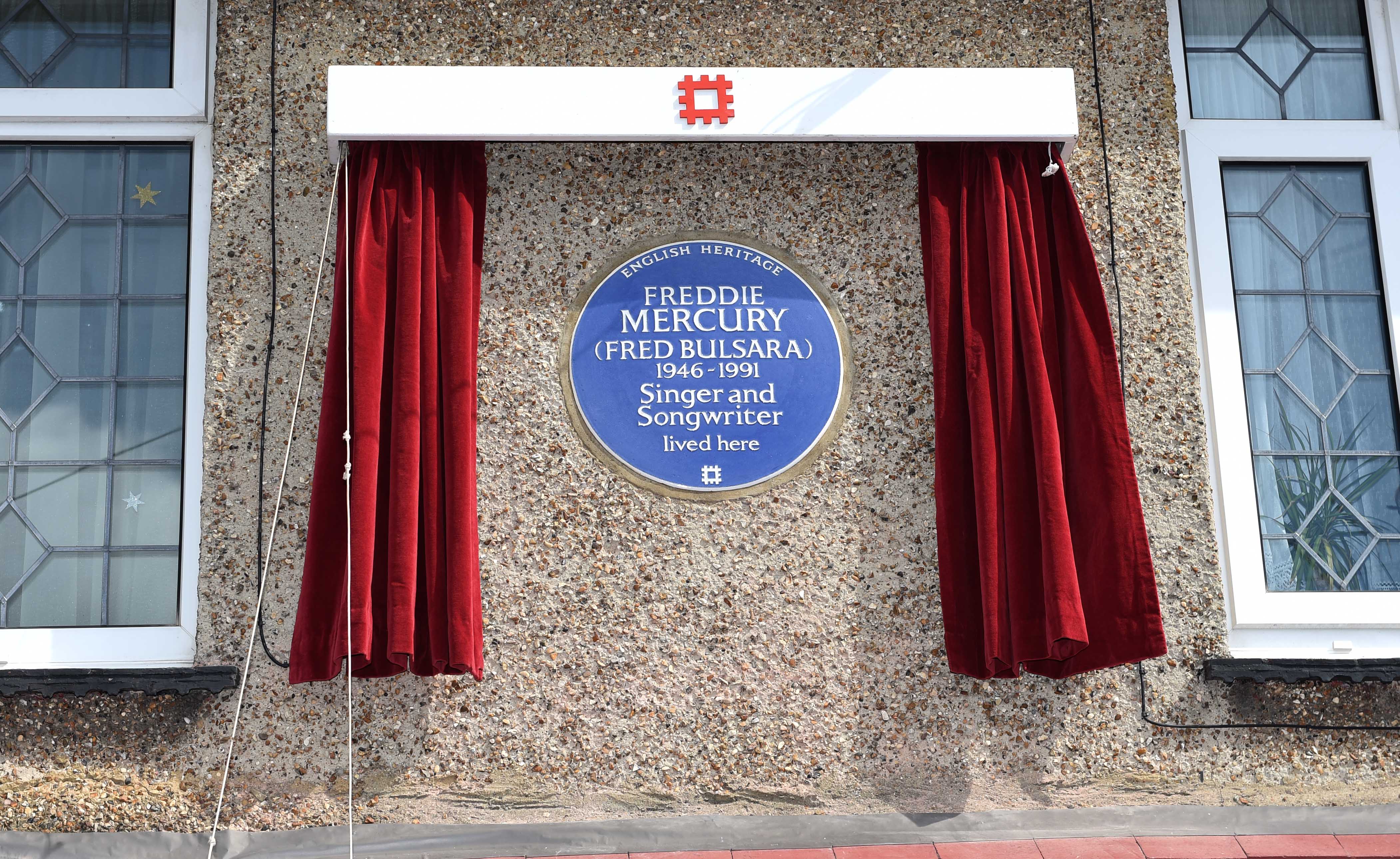 The unveiling of an English Heritage Blue Plaque, commemorating where Freddie Mercury lived in Feltham, England, on Sept. 1, 2016. (Stuart C. Wilson—Getty Images)