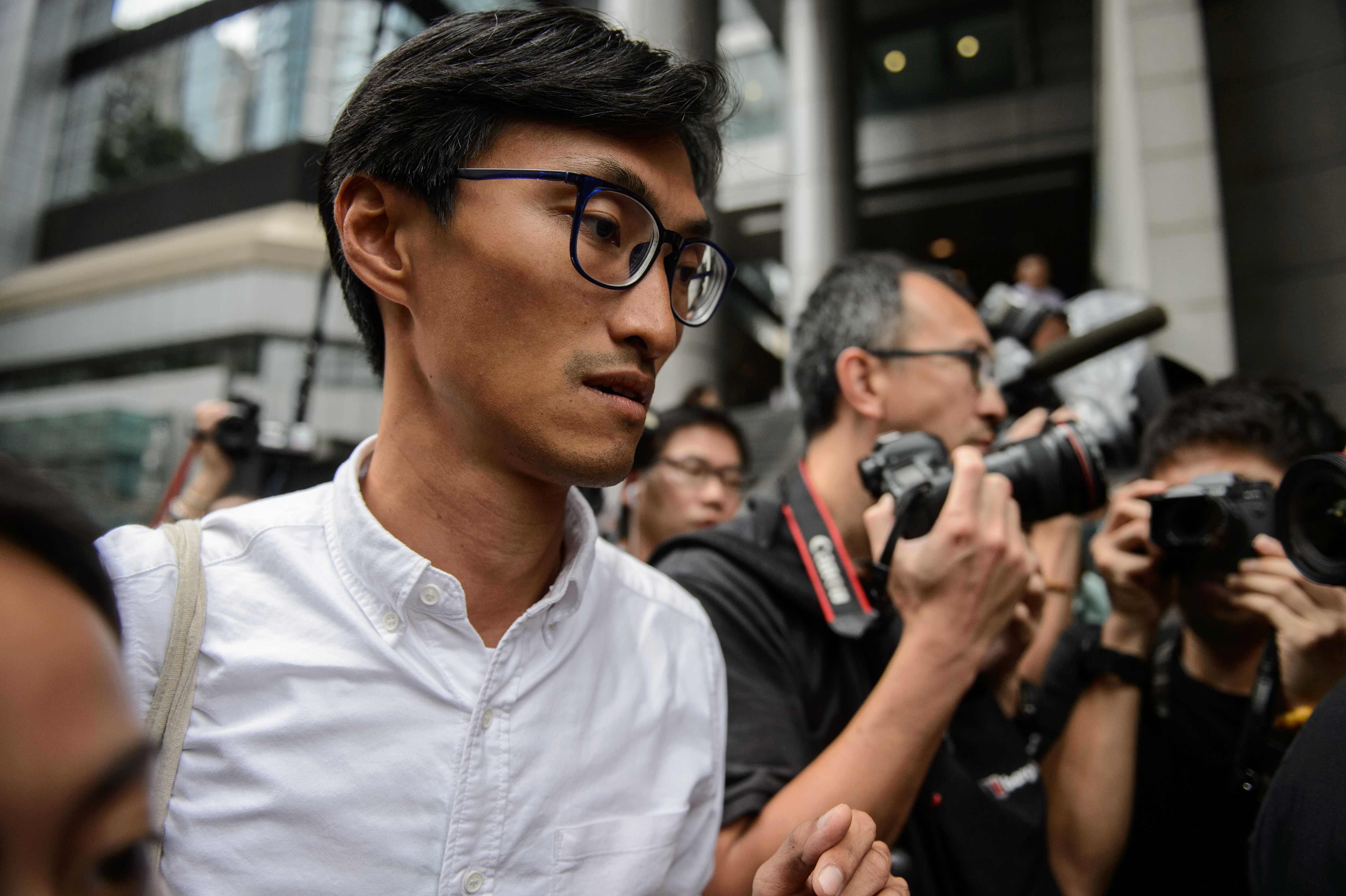 New antiestablishment lawmaker Eddie Chu, left, arrives to make a report to the police in Hong Kong on Sept. 8, 2016 (Anthony Wallace—AFP/Getty Images)