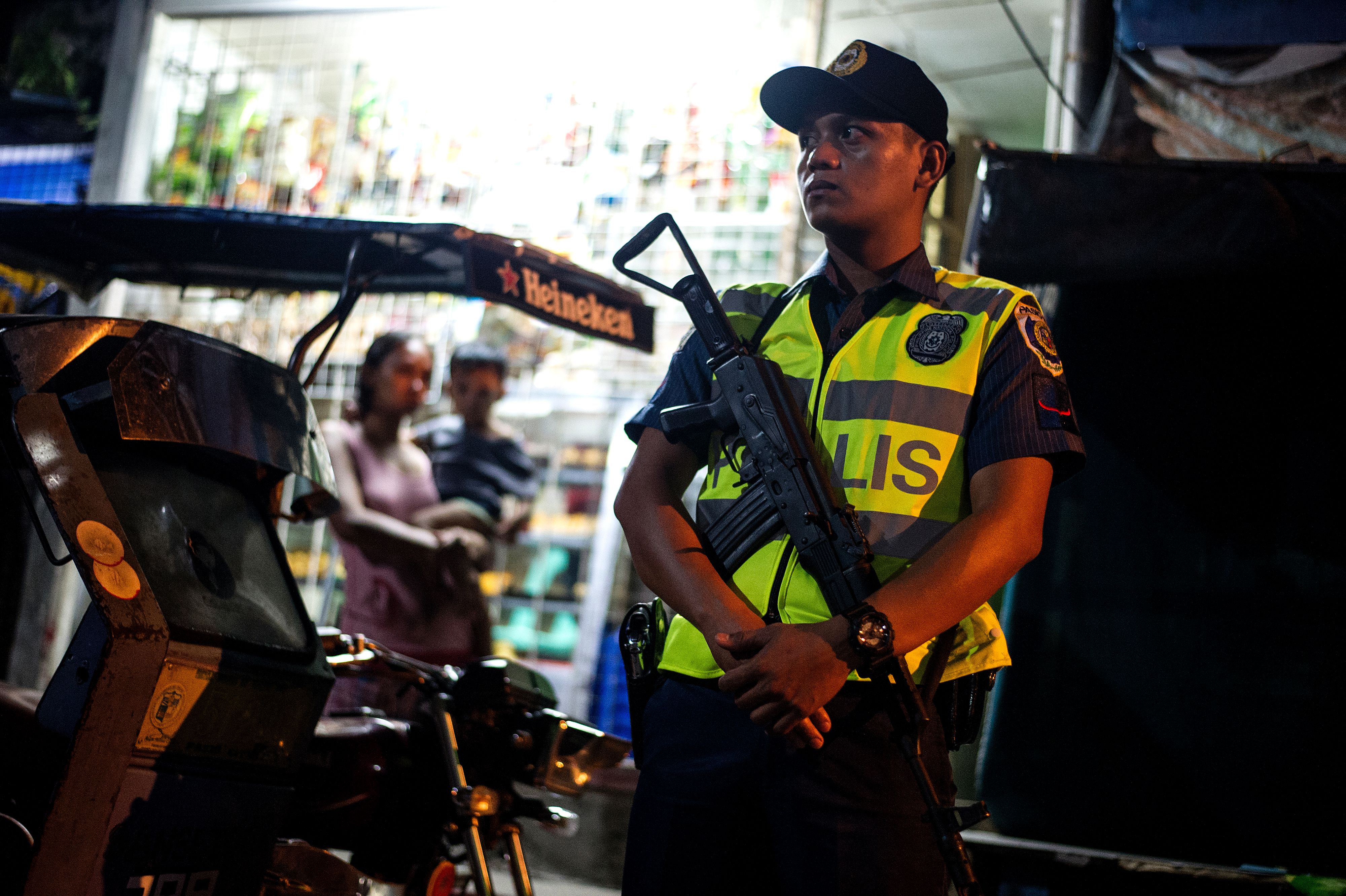 A policeman stands guard on Sept. 14, 2016, in Manila, near a crime scene where a suspected drug dealer was shot dead by unidentified gunmen (Noel Celis—AFP/Getty Images)