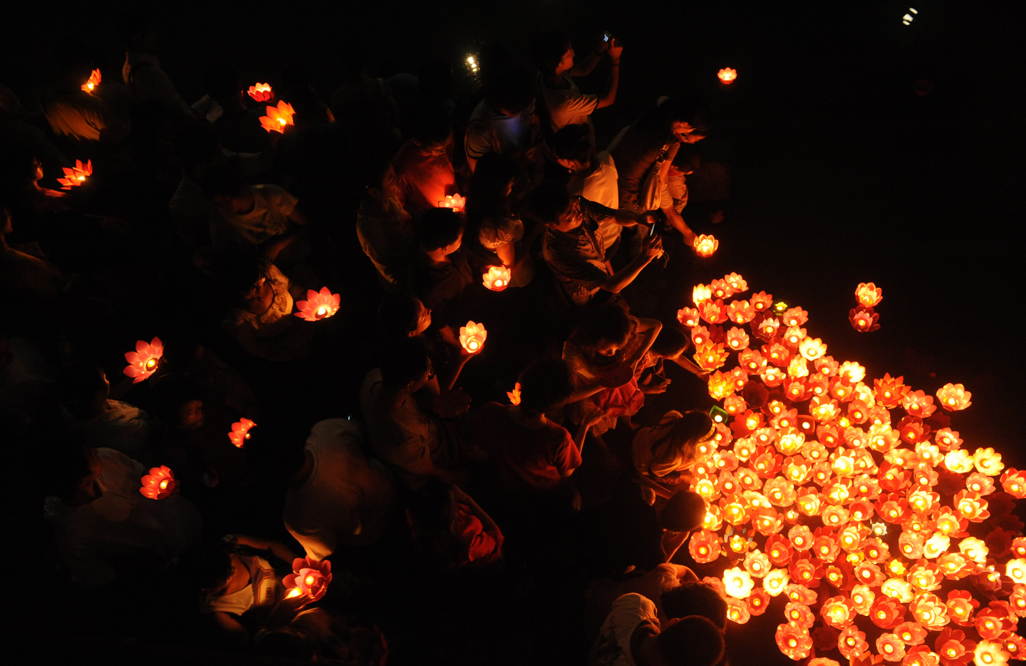 Residents lay candles on a river to mark the Mid-Autumn Festival on Sept. 14, 2008, in Chengdu, Sichuan province, China. (China Photos/Getty Images)