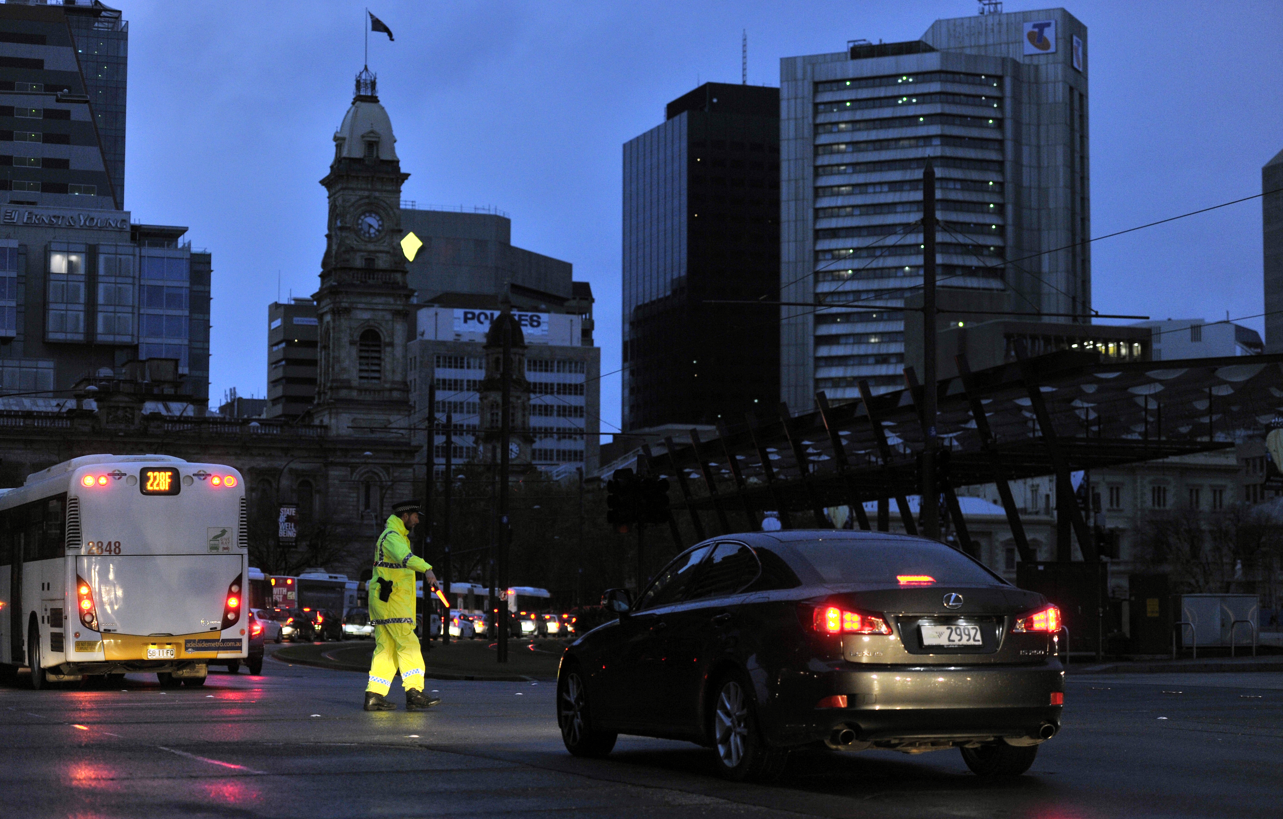 Police direct traffic in Adelaide on Sept. 28, 2016, after the power network stopped working, creating a broad blackout in South Australia (David Mariuz—EPA)