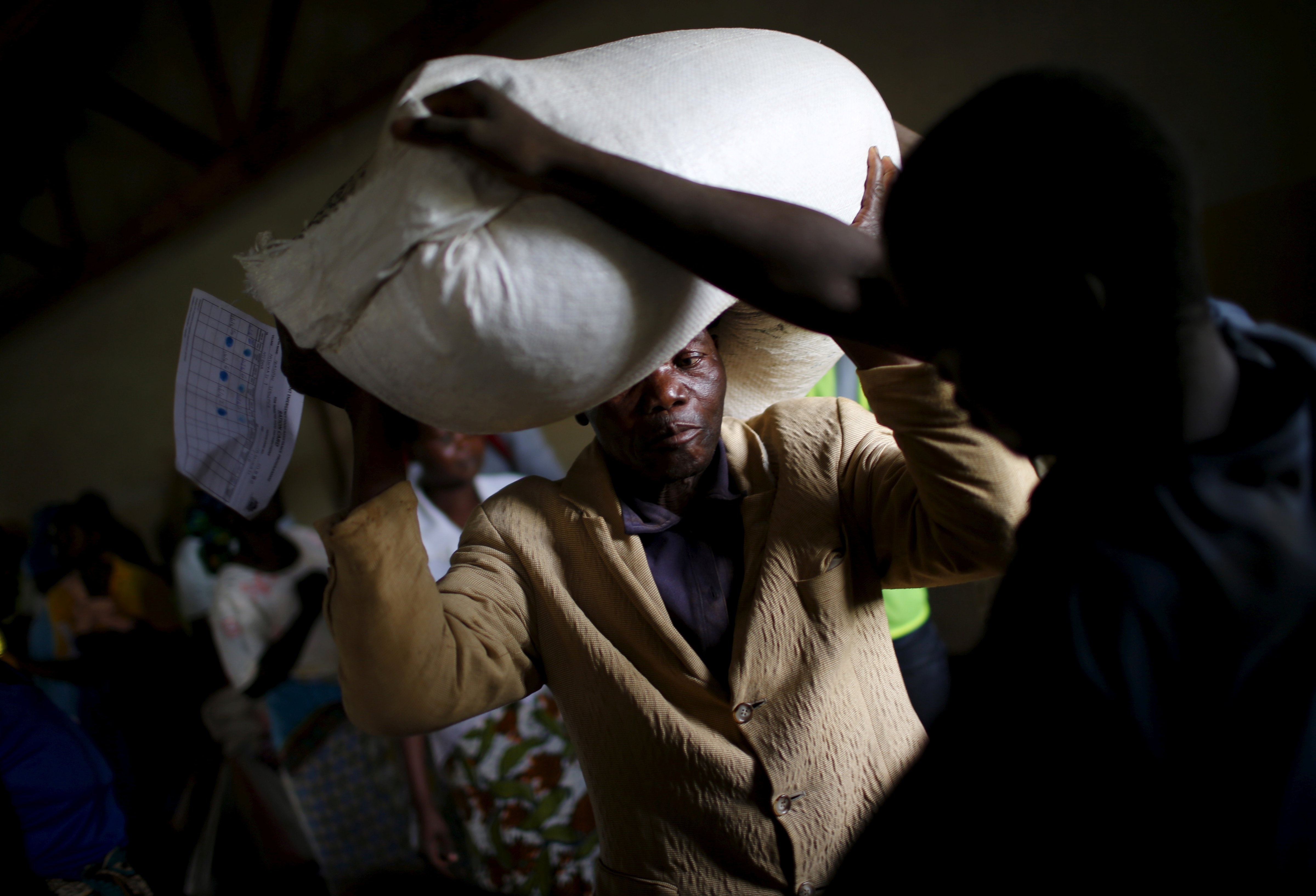 A man carries food aid distributed by the United Nations World Food Progamme (WFP) in Mzumazi village near Malawi's capital Lilongwe, Feb. 3, 2016. (Mike Hutchings—Reuters)