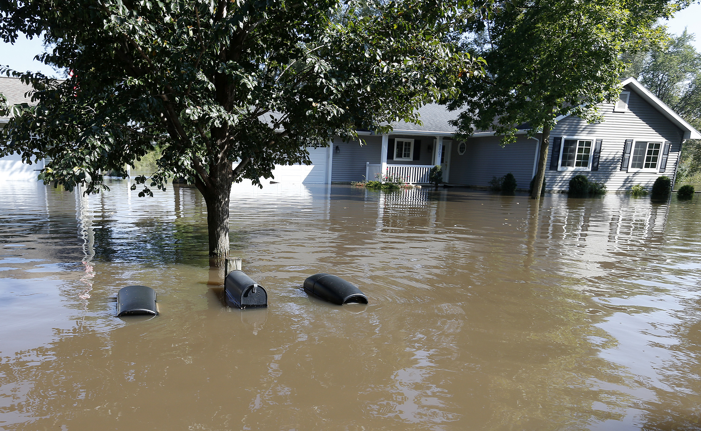The tops of mailboxes barely break the surface of floodwaters from the Cedar River in the North Cedar neighborhood of Cedar Falls, Iowa, Sept. 24, 2016. (Brandon Pollock—The Courier/AP)