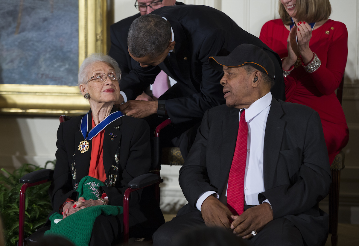 Willie Mays, right, watches as President Barack Obama presents the Presidential Medal of Freedom to NASA mathematician Katherine Johnson during a ceremony in the East Room of the White House, on Nov. 24, 2015, in Washington. (Evan Vucci—AP)