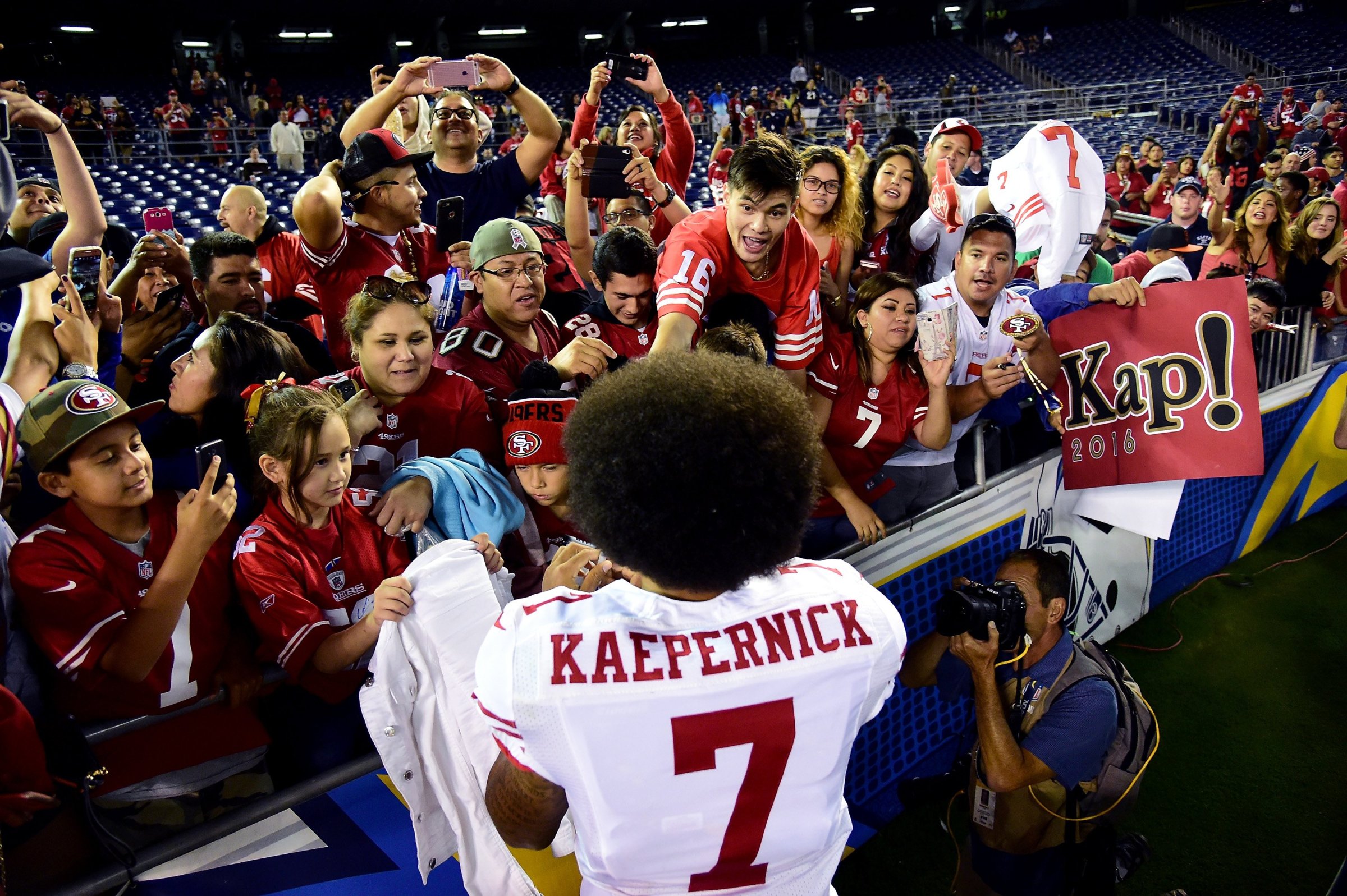 Colin Kaepernick of the San Francisco 49ers signs autographs for fans after a 31-21 win over the San Diego Chargers during a preseason game at Qualcomm Stadium on Sept. 1, 2016 in San Diego.