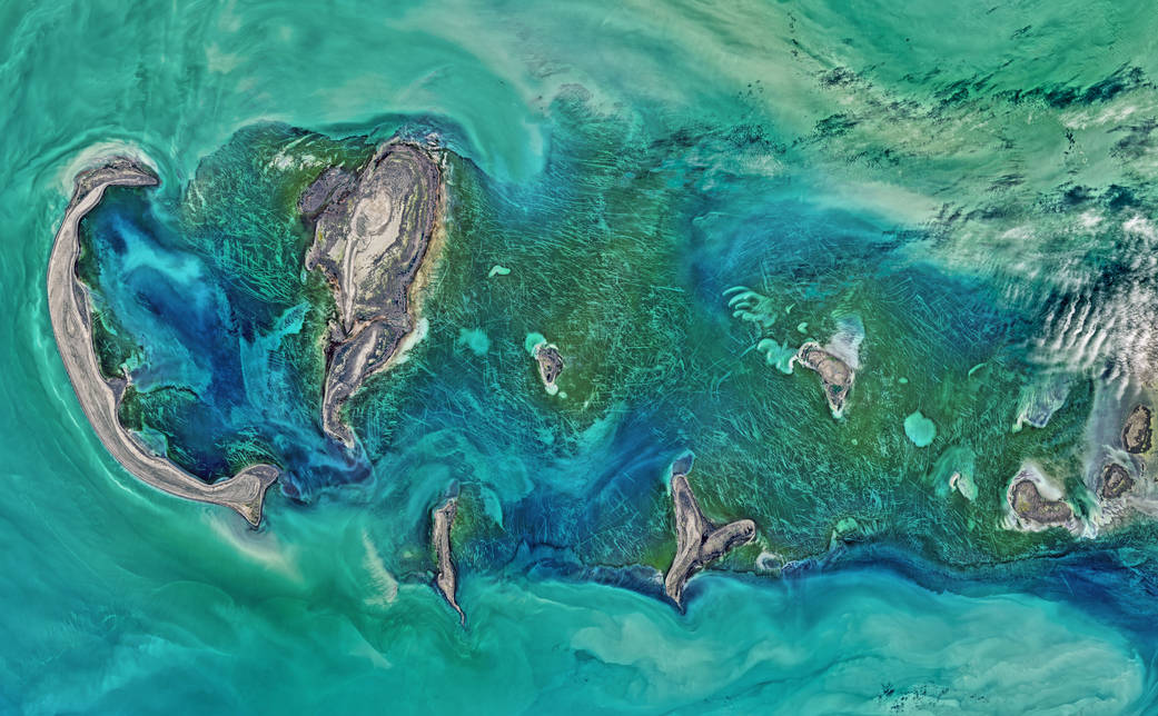 Caspian Sea, Tyuleniy ArchipelagoShallow waters surrounding the Tyuleniy Archipelago allow you to see the dark green vegetation on the sea bottom, which has been gouged by moving ice. April 16, 2016