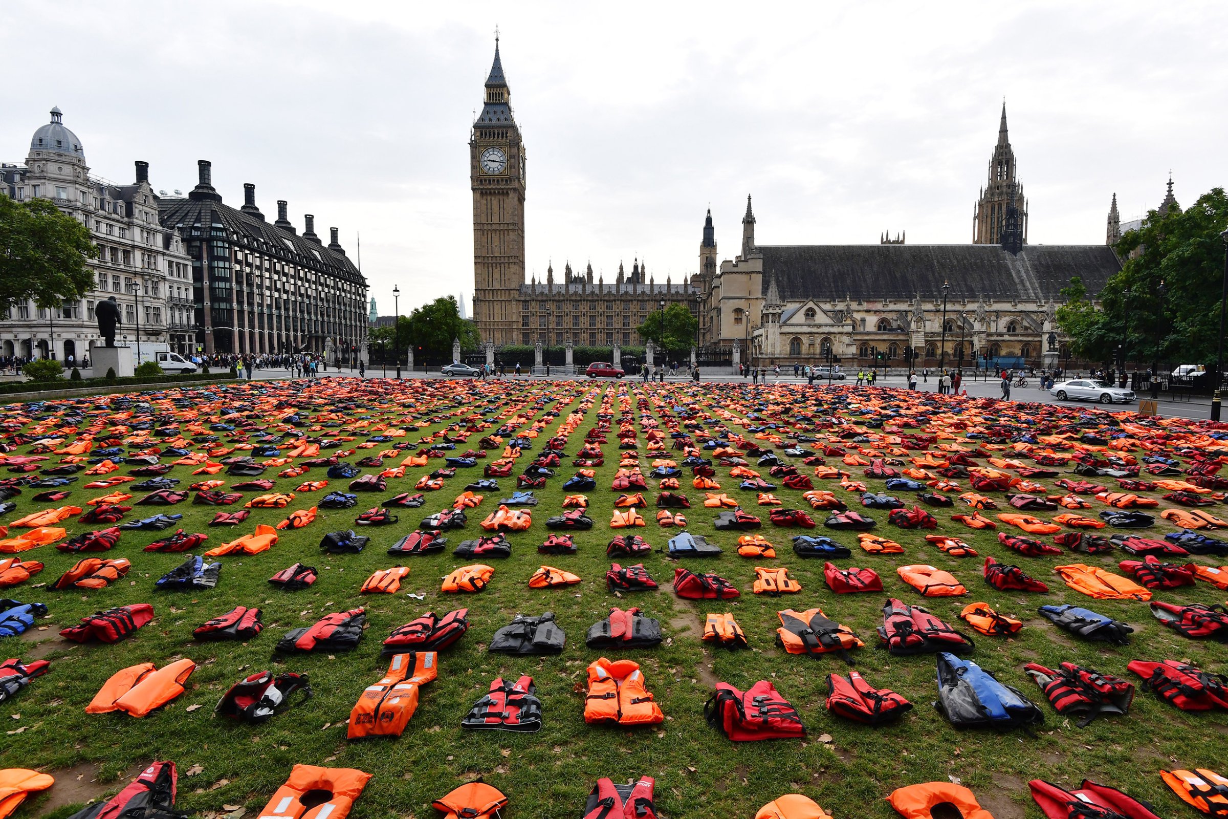 Lifejackets that have been used by refugees to cross the sea to Europe are laid out in Parliament Square in London on Sept. 19, 2016.