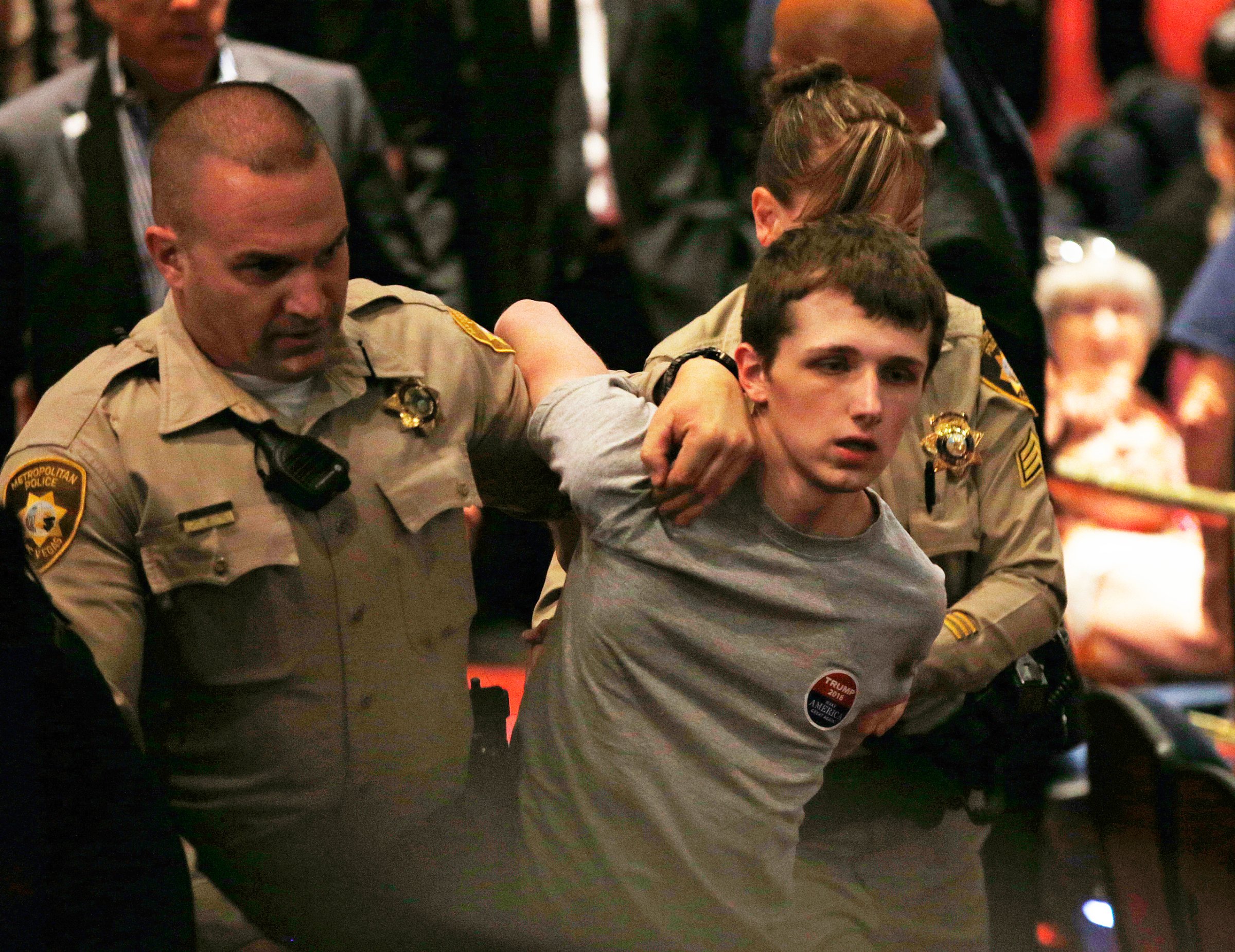 FILE - In this June 18, 2016, photo, police remove Michael Sandford as Republican presidential candidate Donald Trump speaks at the Treasure Island hotel and casino in Las Vegas. The mother of Standford who is accused of attempting to shoot Donald Trump told British television he will plead guilty to lesser charges in a U.S. court. Lynne Sandford, the mother of Michael Sandford, told the station her son has signed a plea agreement in advance of a Nevada court appearance Tuesday, Sept. 13. (AP Photo/John Locher, File)