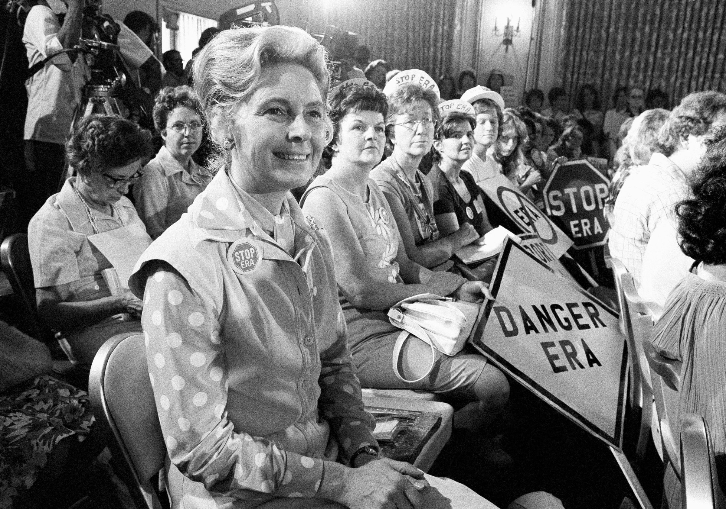 Phyllis Schlafly, left, sit with women opposed to the Equal Rights Amendment during a Republican platform subcommittee hearing in Kansas City, Mo, Aug. 10, 1976.