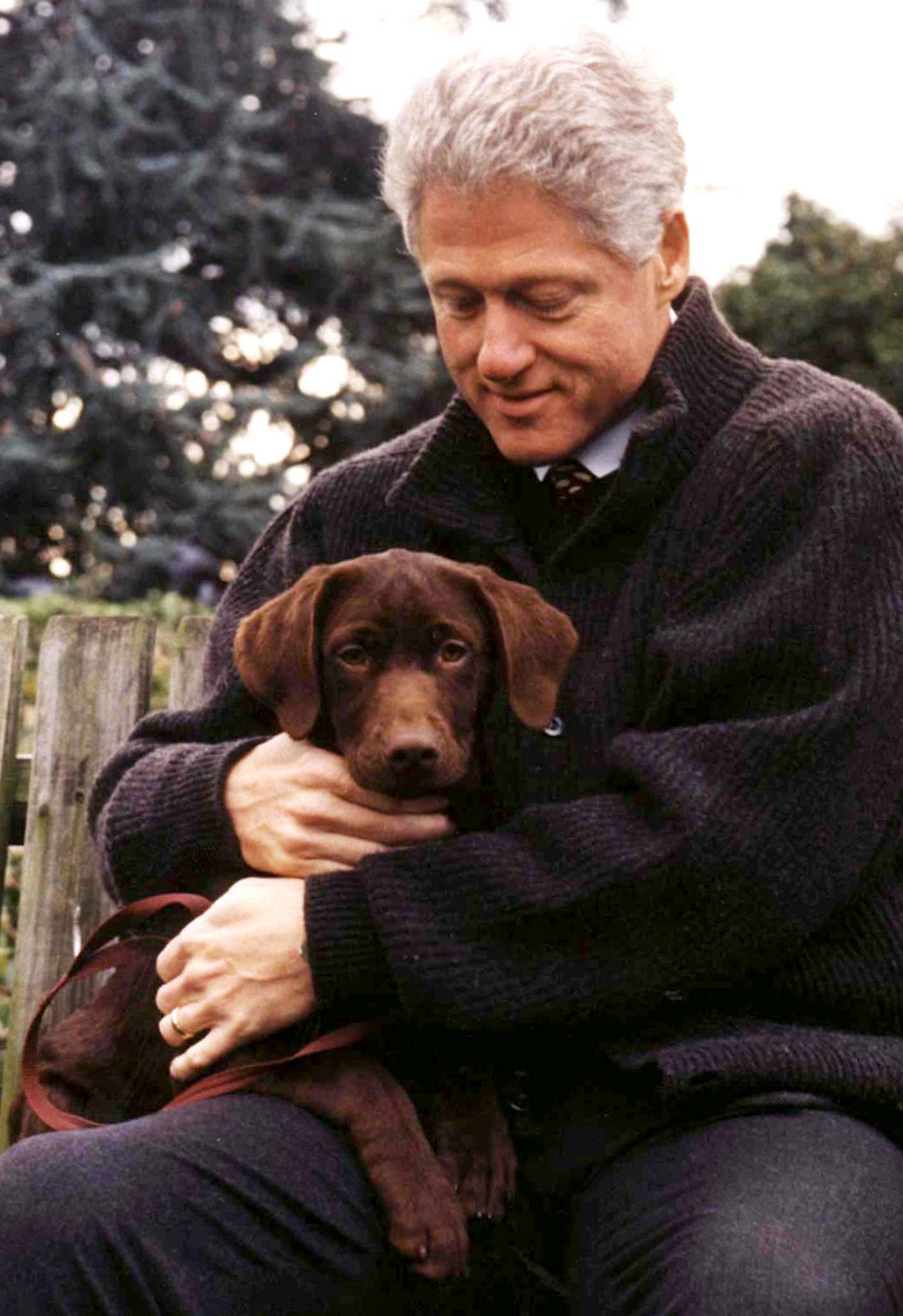 CLINTON HOLDS NEW LABRADOR PUPPY