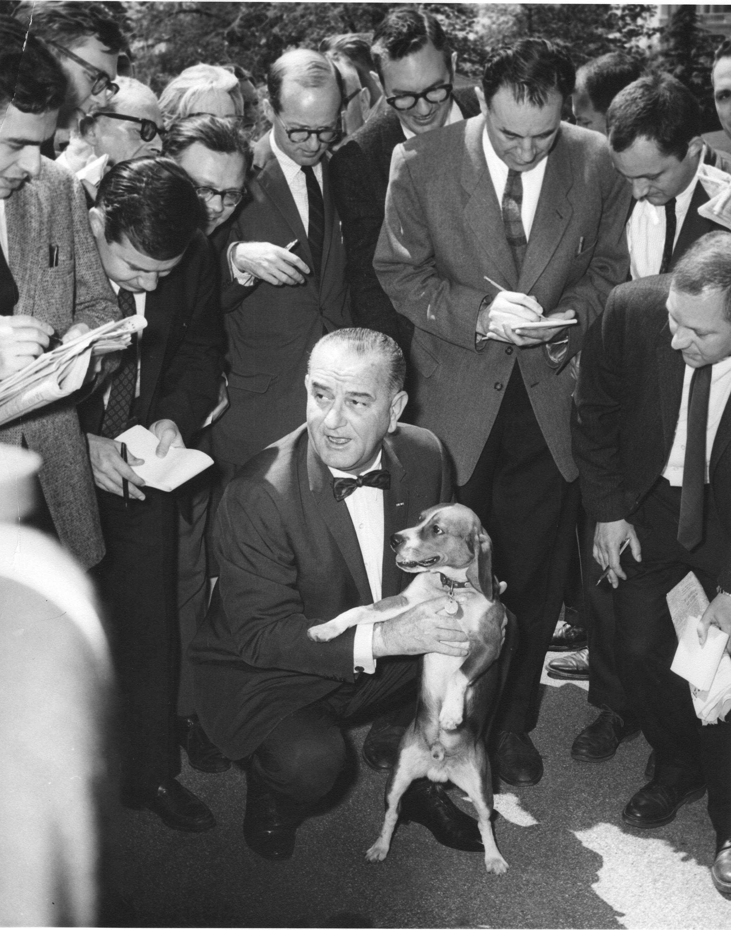 Lyndon Johnson holds one of his beagles, named Him, as he speaks with members of the White House press corps in Washington D.C., May 2 1964.