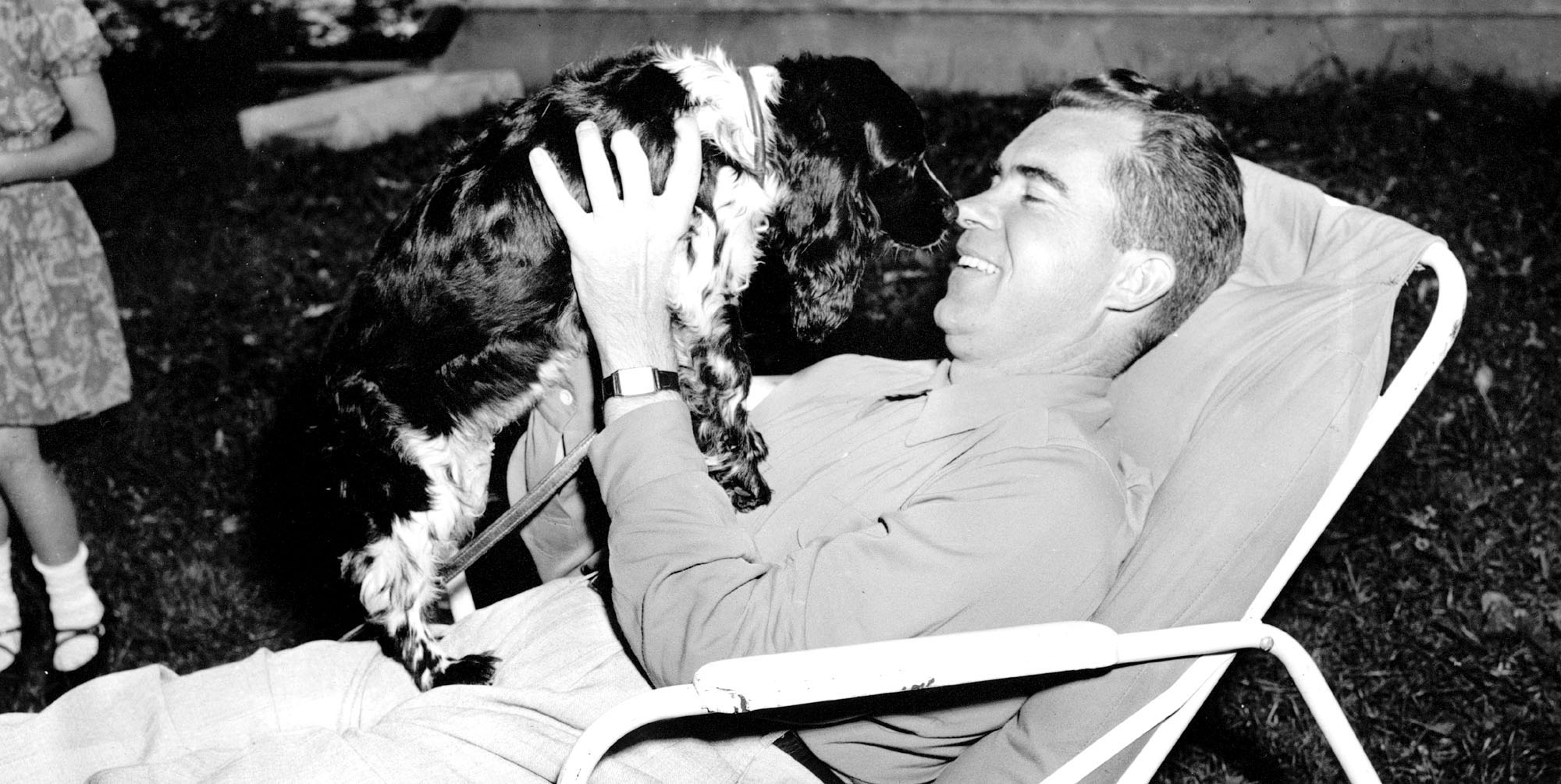 Richard M. Nixon plays with his family's black and white cocker spaniel "Checkers" at his home in Washington on Sept. 28, 1952.