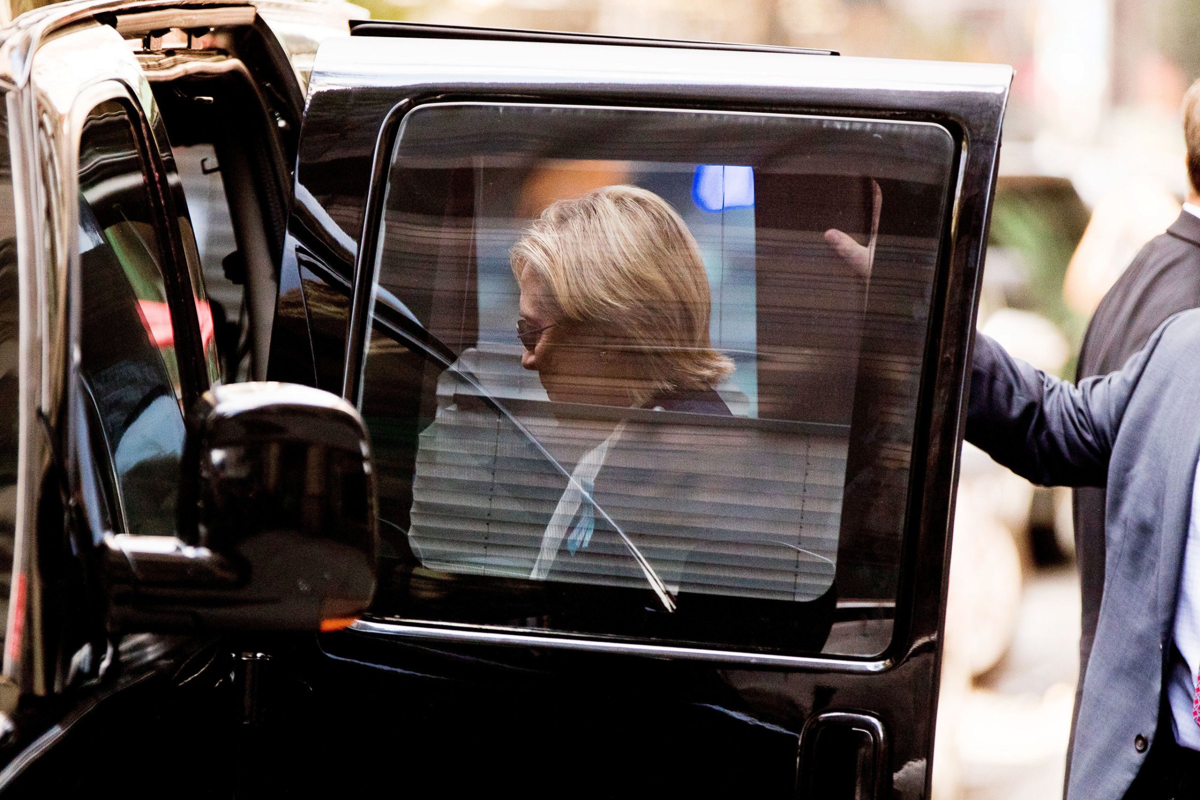Clinton returns to her motorcade after briefly recuperating at her daughter Chelsea’s apartment