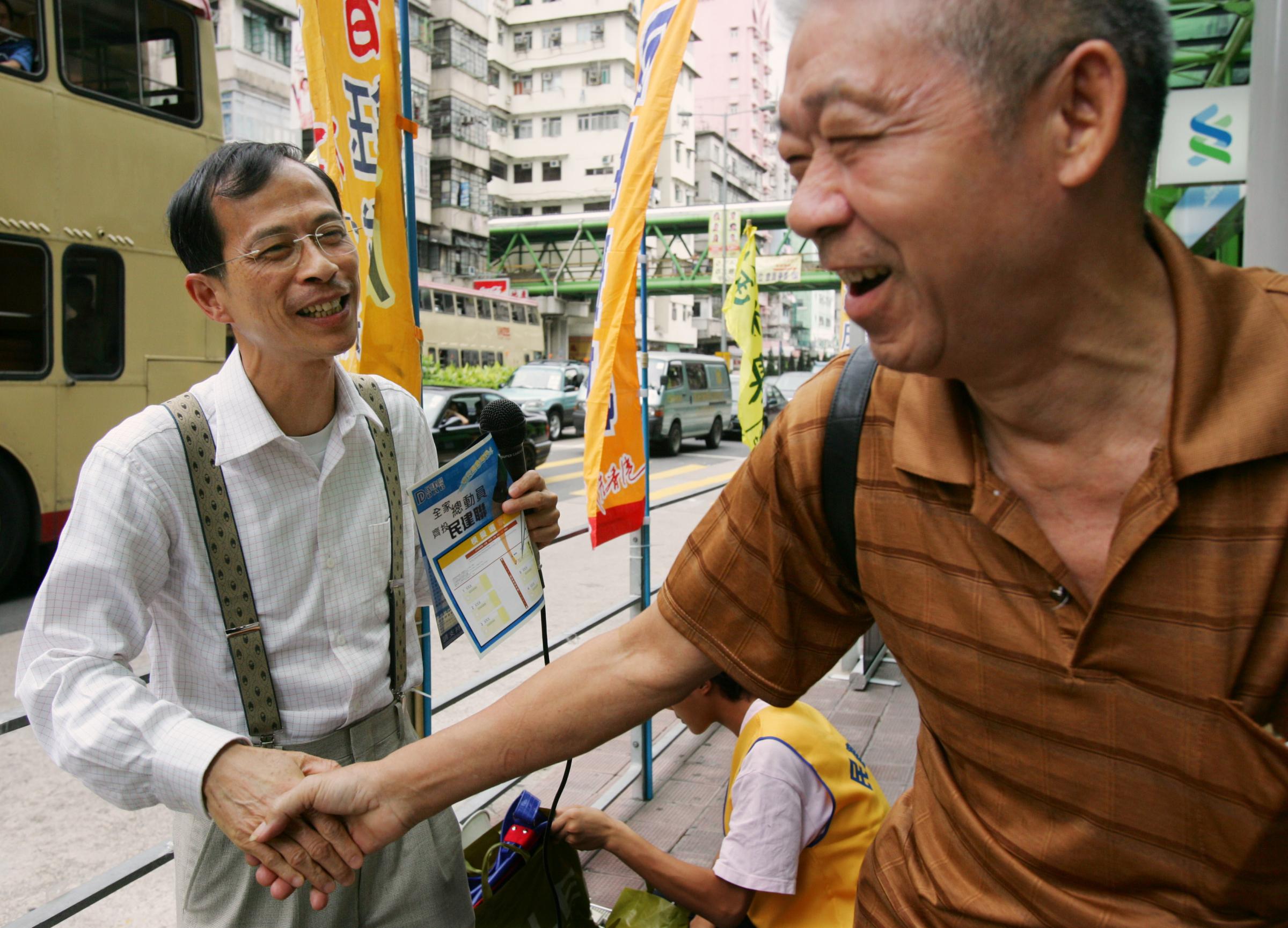 Tsang Yok-sing shakes hands with a supporter in Hong Kong.