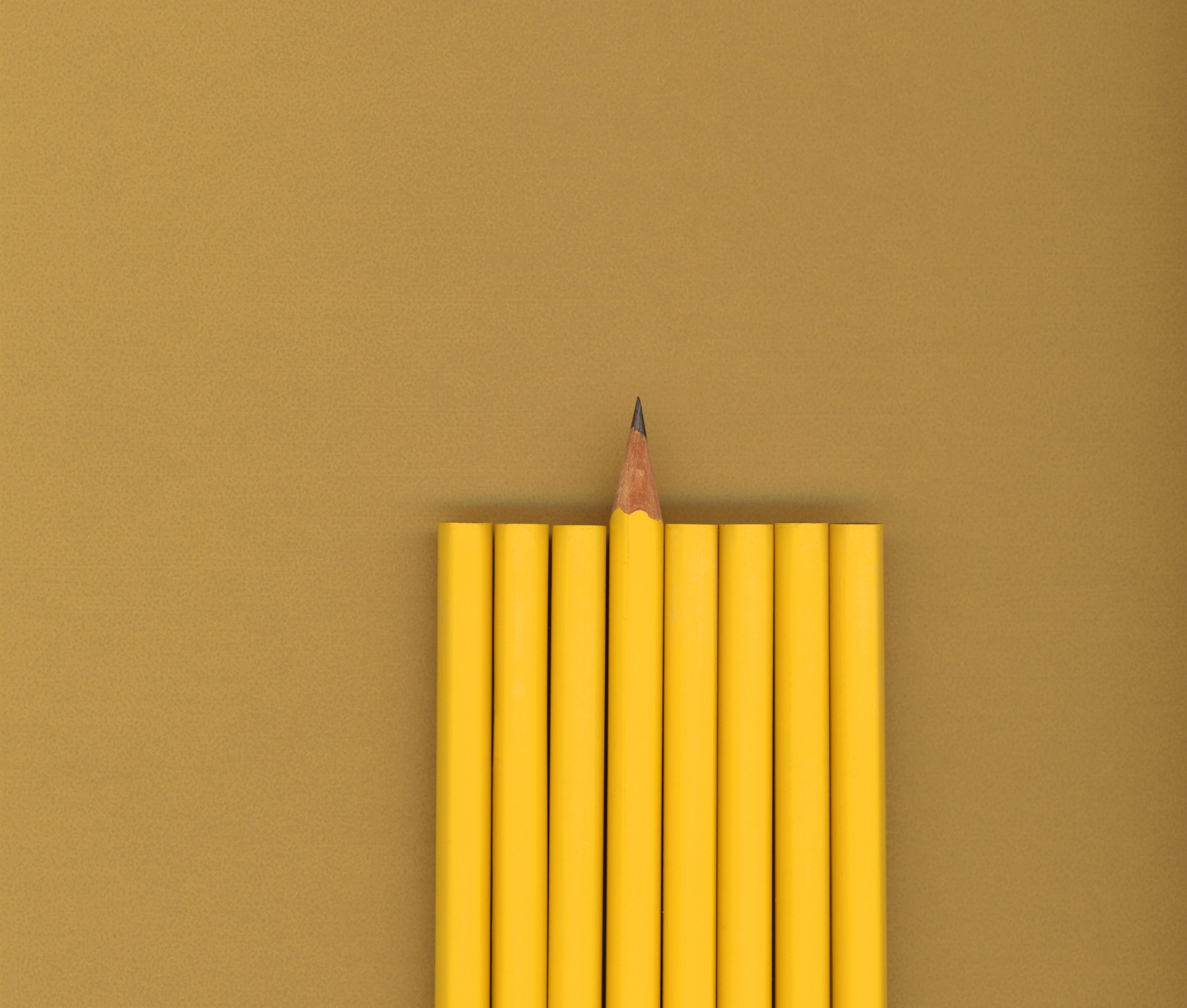 Sharpened pencil next to unsharpened pencils