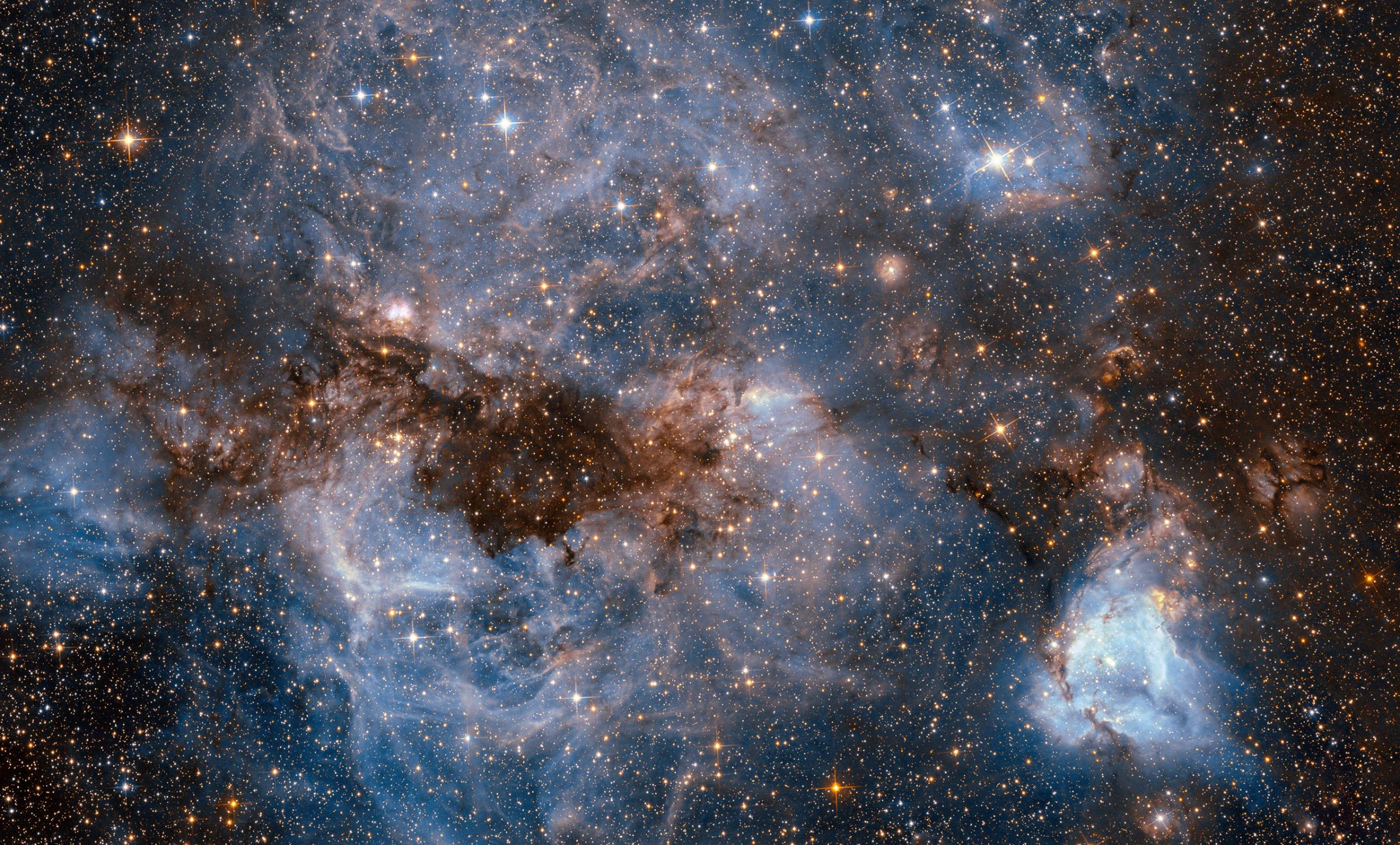 A maelstrom of glowing gas and dark dust within one of the Milky Way’s satellite galaxies, the Large Magellanic Cloud (LMC). This stormy scene shows a stellar nursery known as N159, an HII region over 150 light-years across. Sept. 5, 2016.