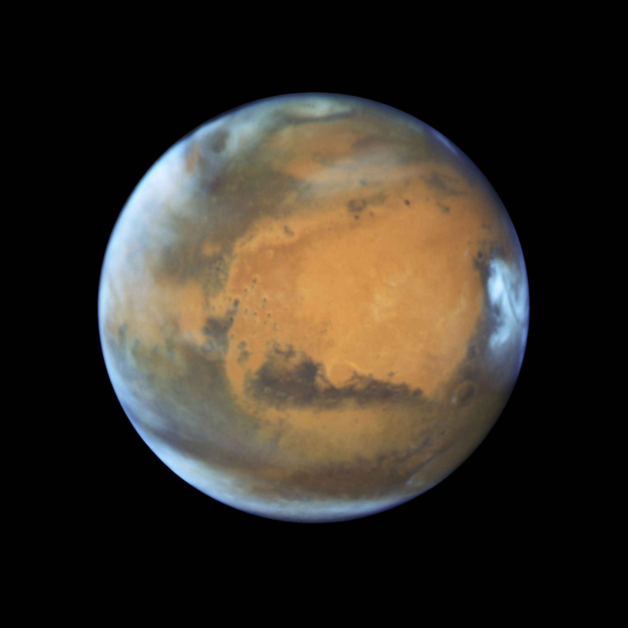 Bright, frosty polar caps, and clouds above a vivid, rust-colored landscape reveal Mars as a dynamic seasonal planet on May 12, 2016.