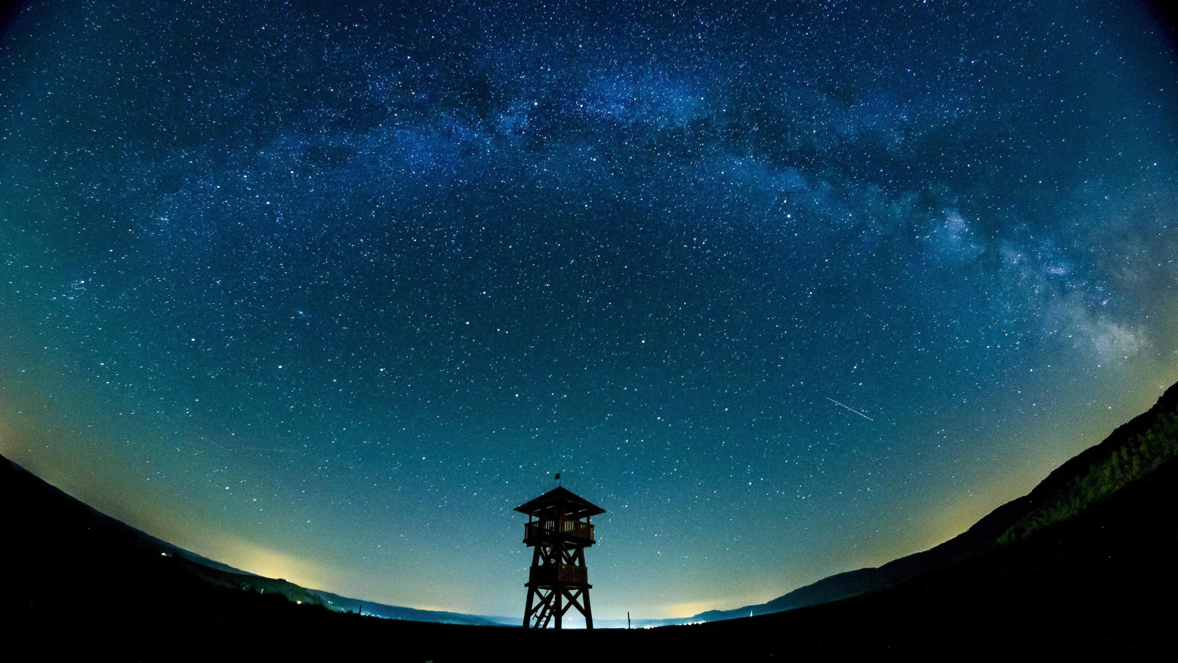 The Milky Way is observed behind a lookout tower near the Hungarian border village of Tachty, or Tajti in Hungarian, Slovakia, Aug. 28, 2016.