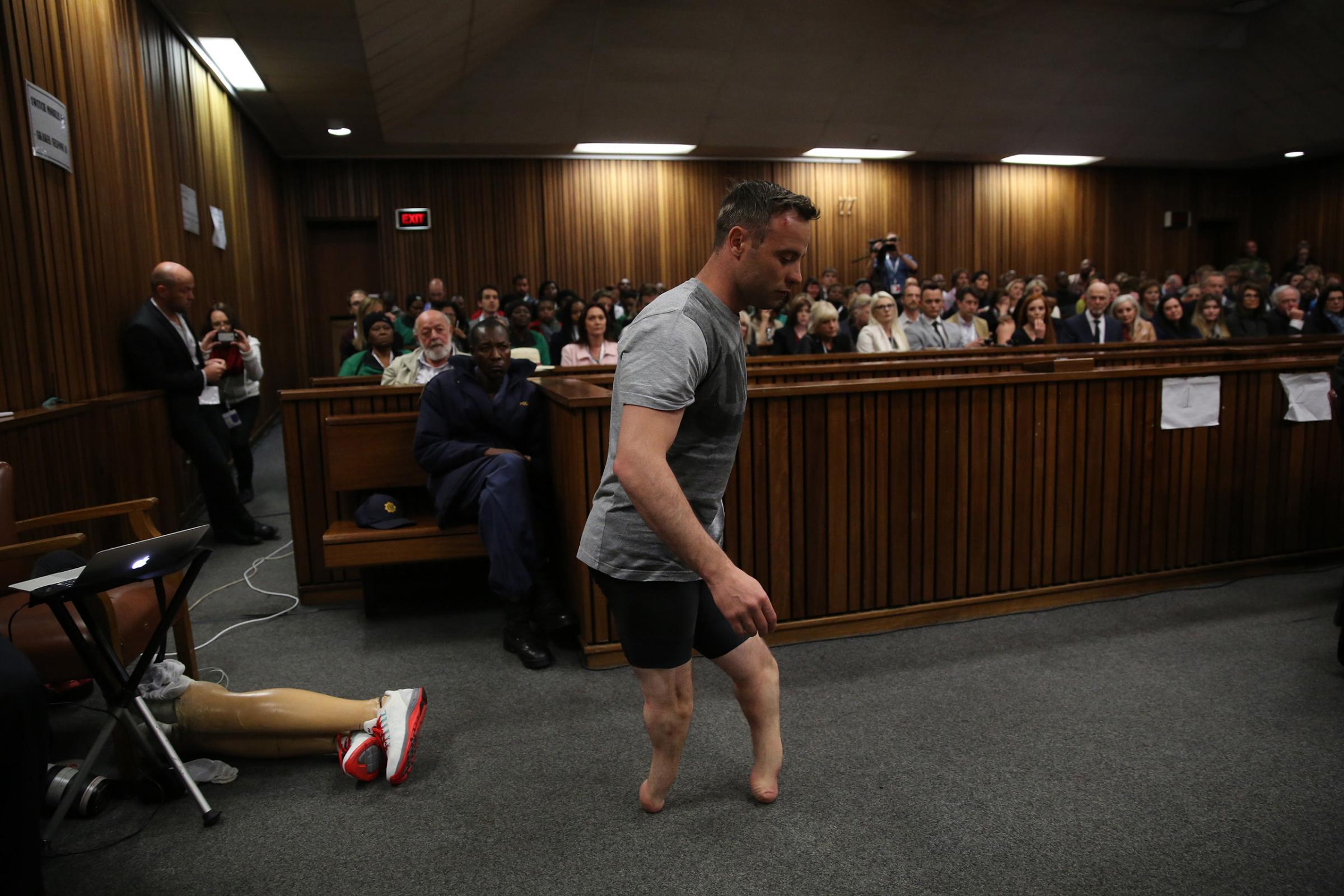 Paralympic gold medalist, Oscar Pistorius, prepares to walk across the courtroom without his prosthetic legs during the third day of his hearing at the Pretoria High Court for sentencing procedures in his murder trial in Pretoria on June 15, 2016.