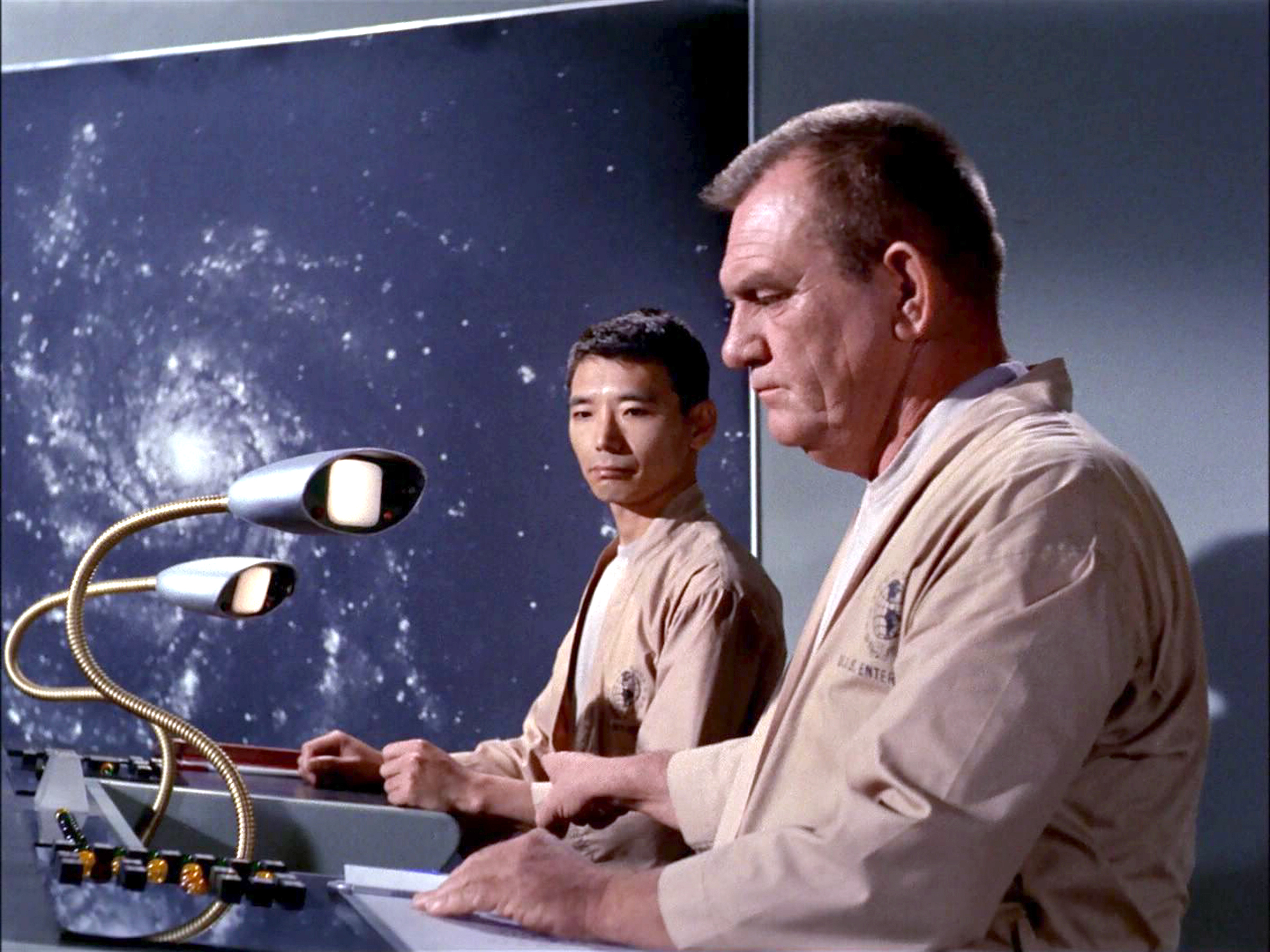 Crew members in the transport room of the USS Enterprise.