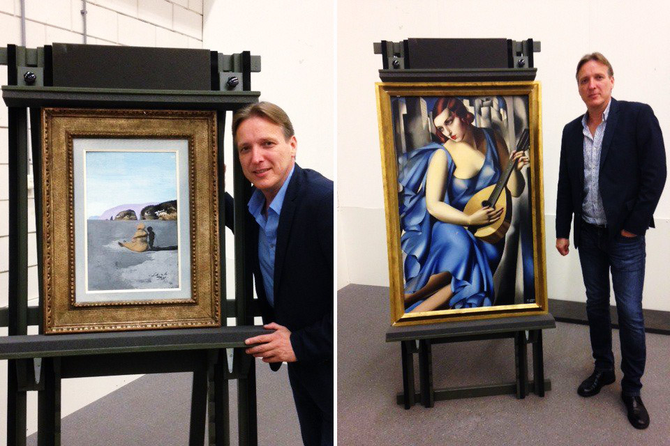 Art investigator Arthur Brand stands with two paintings he recovered, "Adolescence" by Salvador Dali and "La Musicienne" by Tamara de Lempicka, July 26, 2016.
