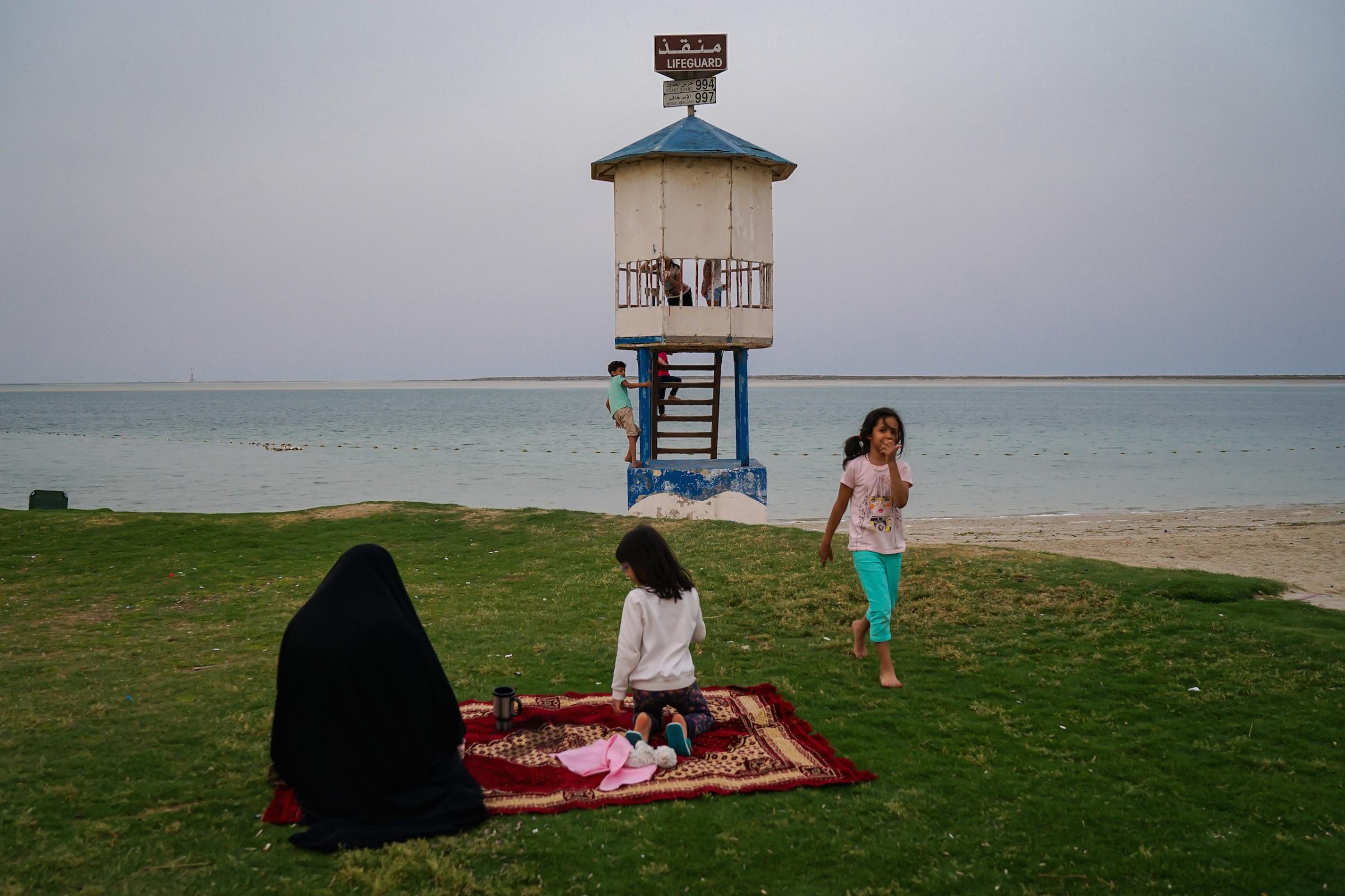 A six-year-old girl walks out of the lifeguard booth full of kids, but no lifeguard, in Jubail Industrial City, April 2016. "Why are you taking a picture?" she asked the photographer, who replied, "perhaps because these images preserve time?" Her father was standing nearby. The girl then said, "I will remember that I can't swim here, but my brother can," before returning to play with other children.