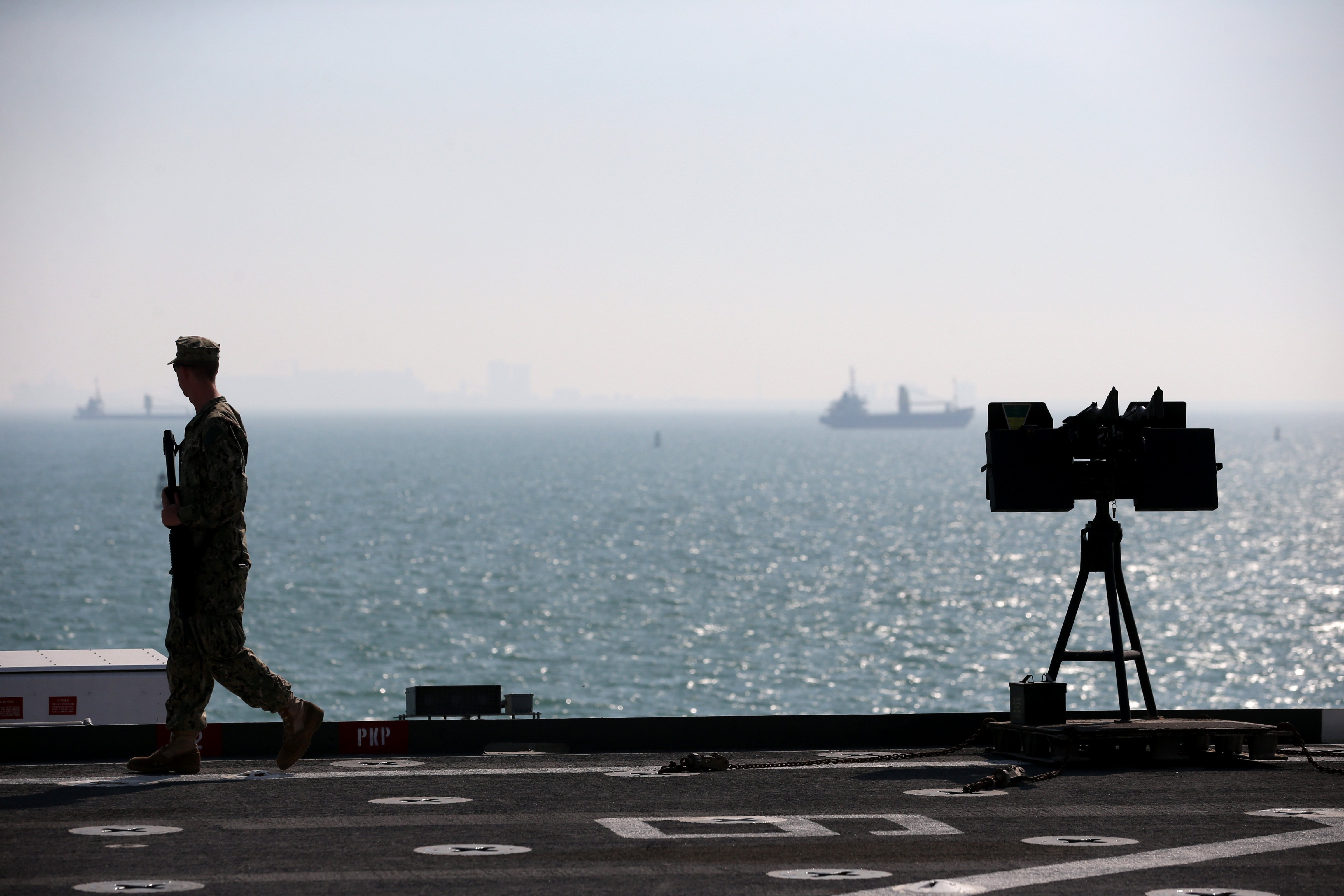 A Military guard patrols the deck of the USS Ponce where US Secretary of State Chuck Hagel was touring, on Dec. 6, 2013 in Manama, Bahrain. (Mark Wilson—Getty Images)
