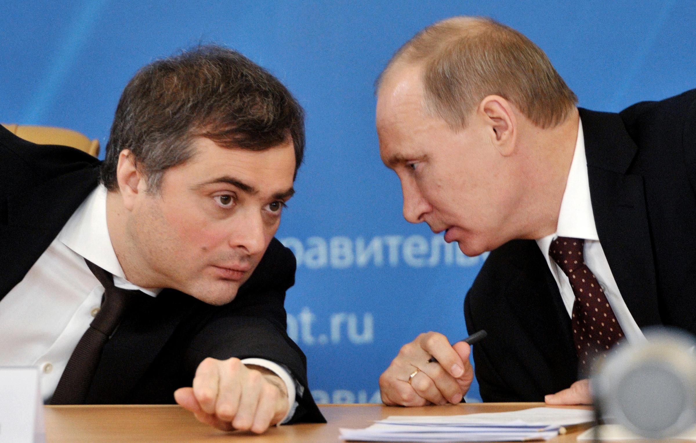 In this Feb. 13, 2012, file photo, Vladimir Putin, then Russia's Prime Minister, confers with his deputy, Vladislav Surkov, during a meeting on the modernization of the secondary education in the Urals city of Kurgan.