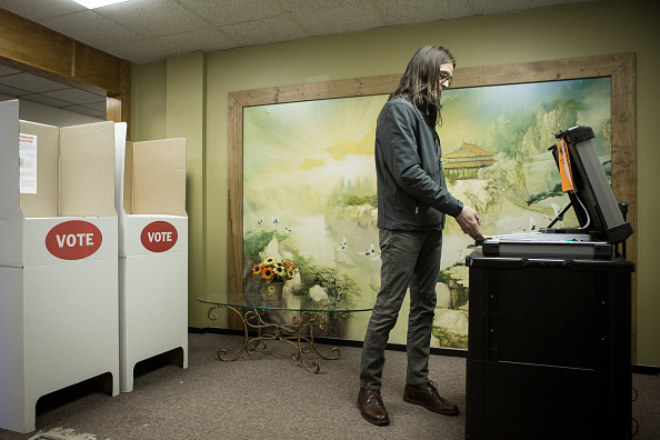 Scott Stuckey of Oklahoma City feeds a ballot into an optical scanner at Trinity Baptist Church on Super Tuesday March 1, 2016 in Oklahoma City.  Oklahoma voters head to the polls for the 2016 Presidential Primary.