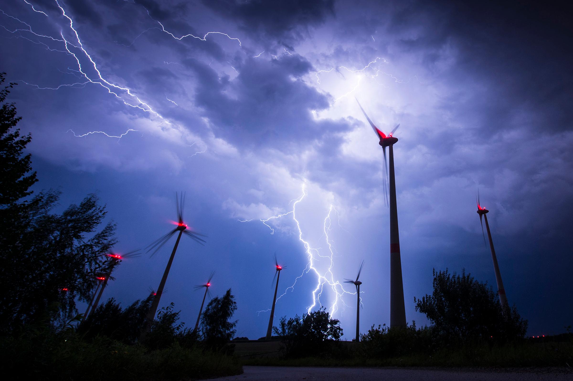 Lightning strikes behind wind turbines during a thunderstorm in Goerlitz, Germany, on Aug. 28, 2016.