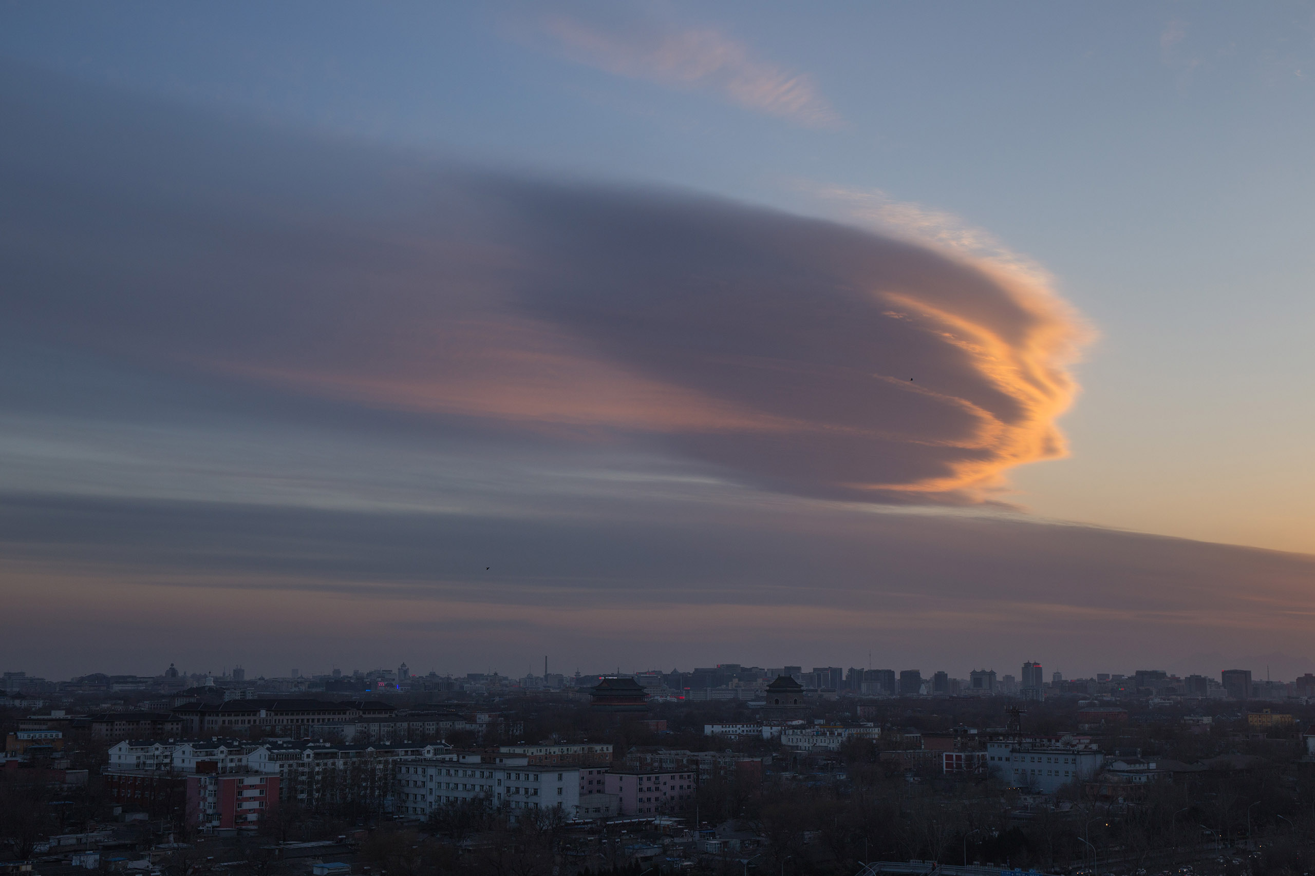 A meteorite-shaped cloud floats in the sky at nightfall in Beijing, on March 7, 2016.