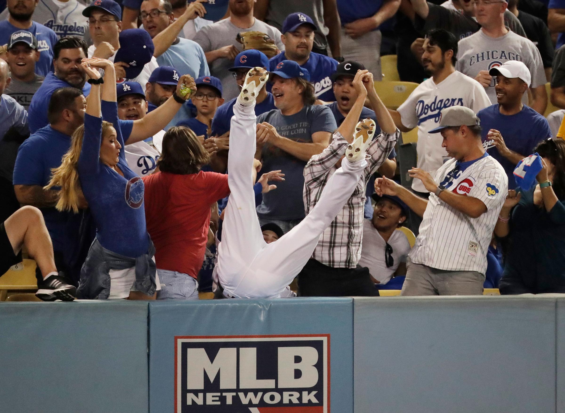 Los Angeles Dodgers right fielder Josh Reddick can't catch a foul ball hit by Chicago Cubs' Ben Zobrist during the fifth inning of Game 4 of the National League baseball championship series, on Oct. 19, 2016, in Los Angeles.