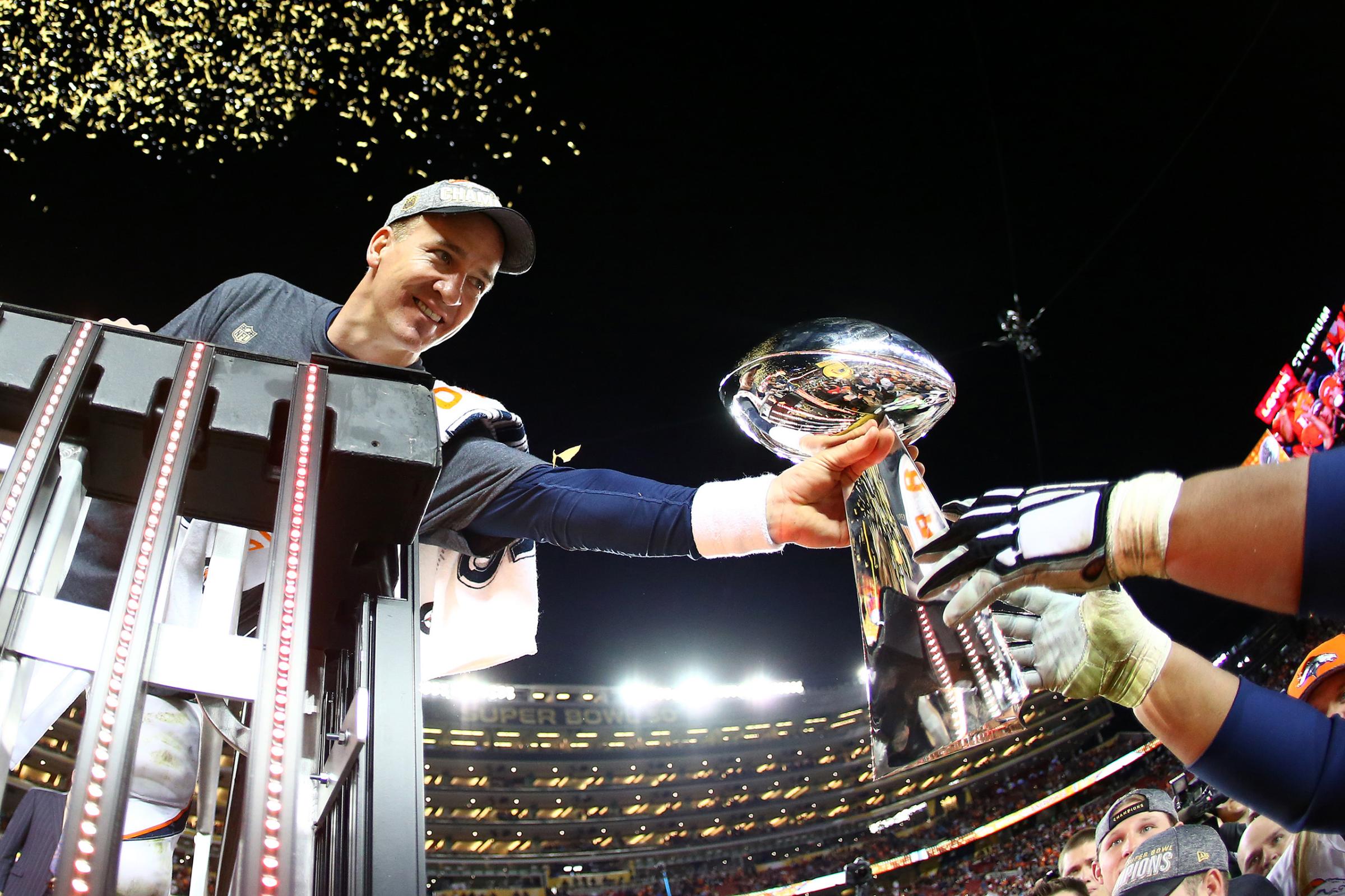 Peyton Manning of the Denver Broncos is handed the Vince Lombardi Trophy after defeating the Carolina Panthers during Super Bowl 50 at Levi's Stadium on Feb. 7, 2016 in Santa Clara, California.