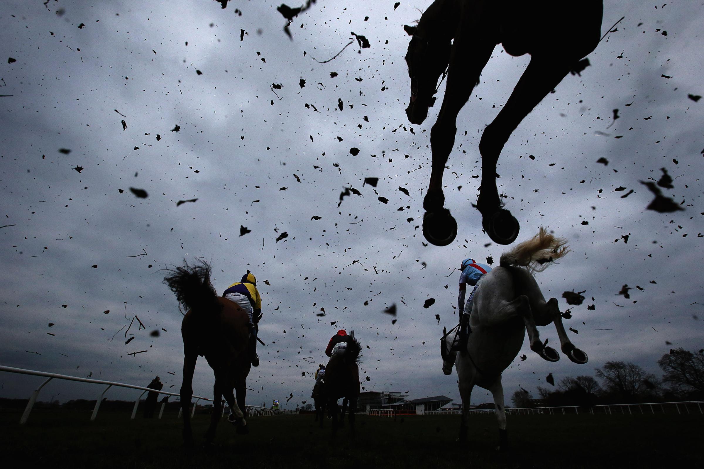 Horses clear a fence during the Racing UK Profits Returned To Racing Handicap Steeple Chase at Wetherby Racecourse on March 22, 2016 in Wetherby, England.