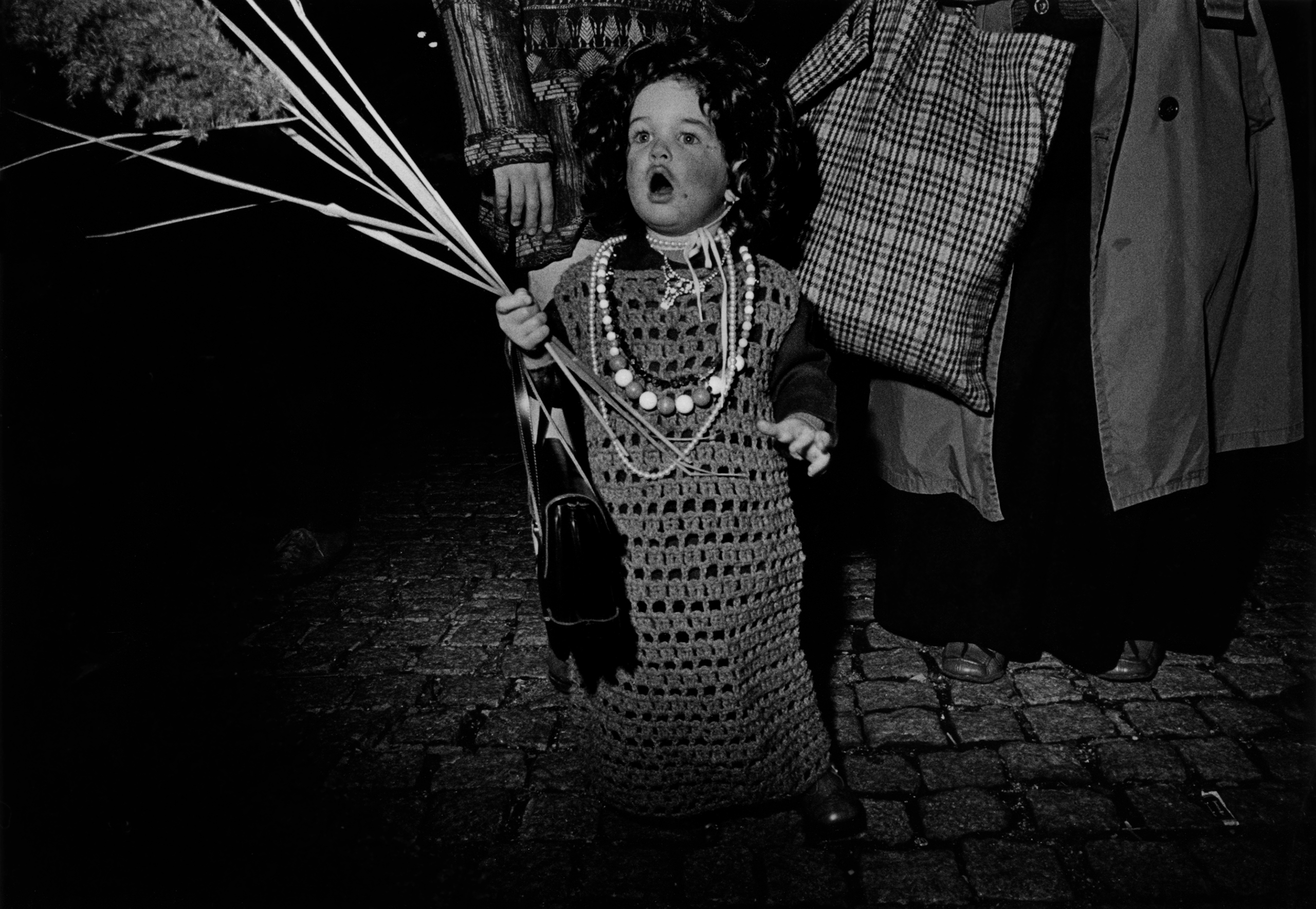 A young boy with balloons at the New York City Halloween Parade, 1976.