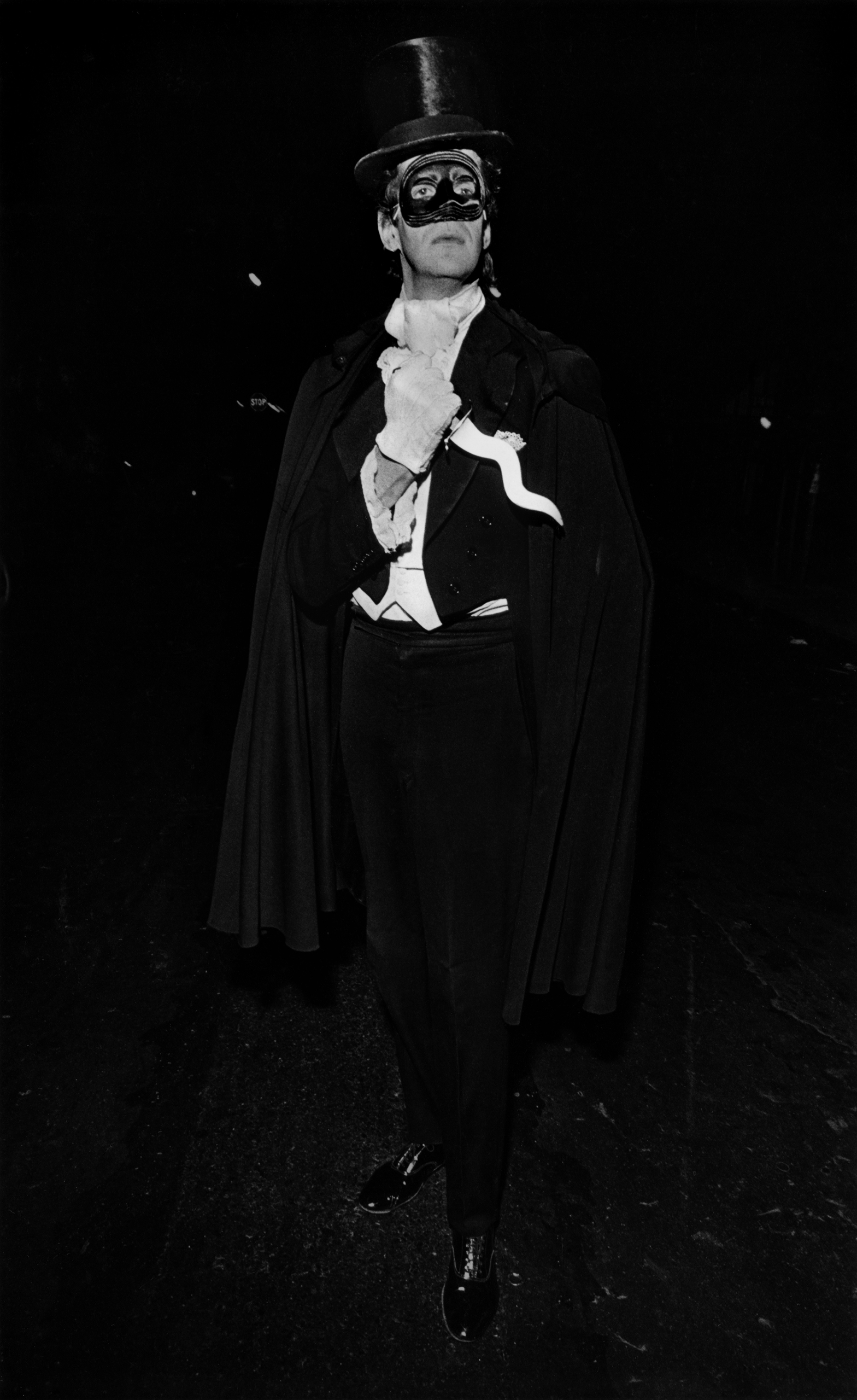 A dapper man with a dagger strikes a pose at the New York City Halloween Parade, 1978.