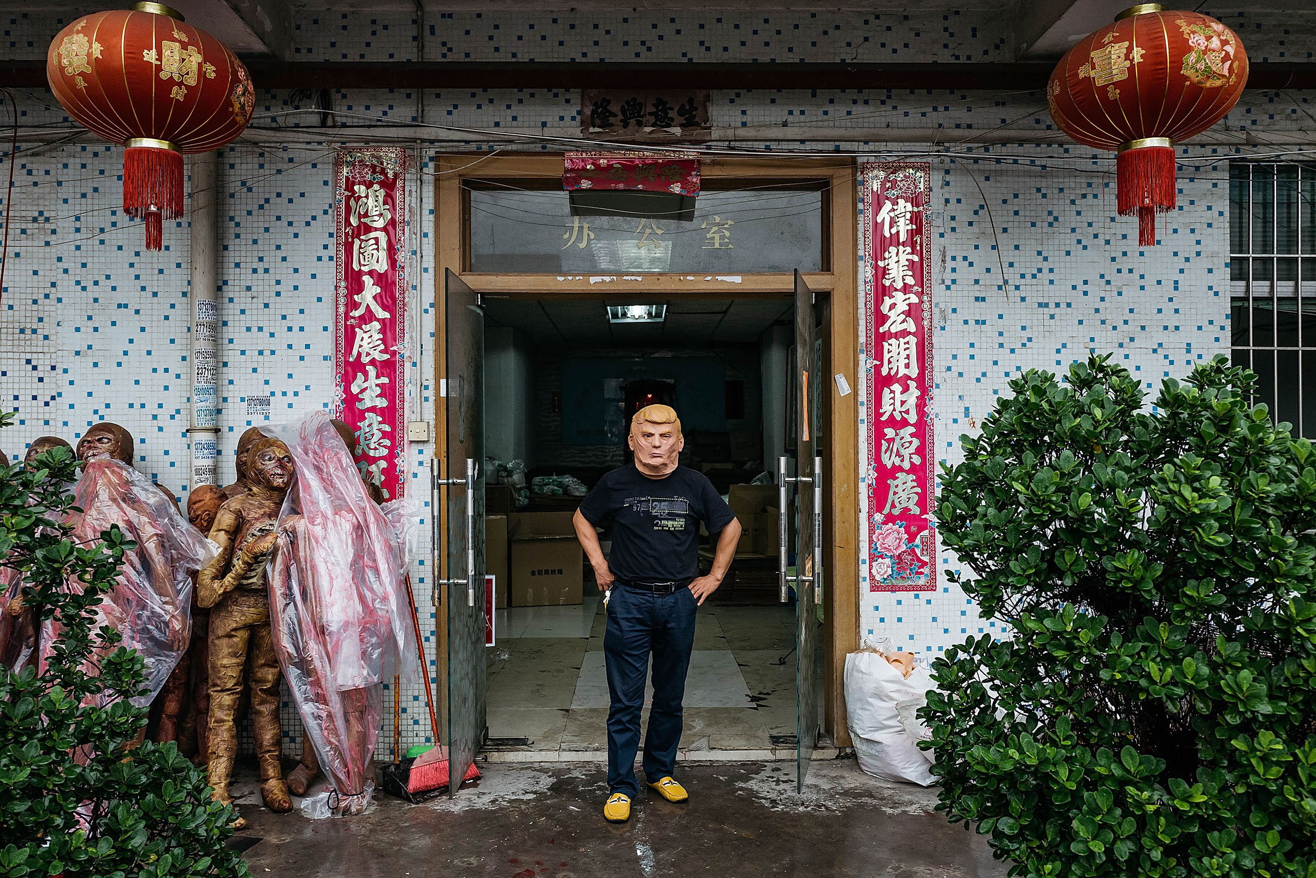 An employee wearing a mask of Donald Trump poses for a photograph at the Shenzhen Lanbingcai Latex Crafts Factory in Shenzhen, China, on Oct. 18, 2016. The factory runs a small scale production of Donald Trump masks for local distribution within mainland China.