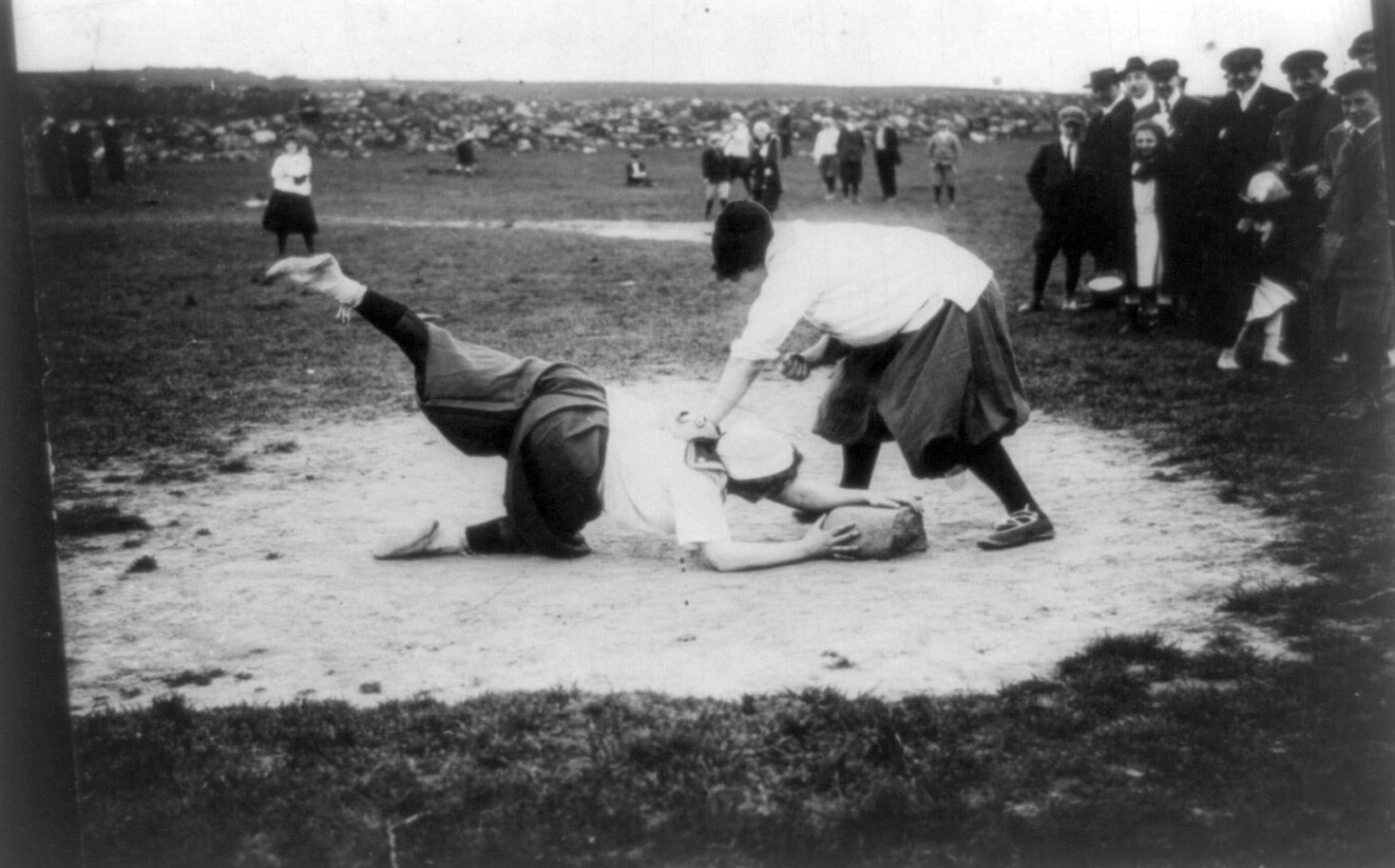Miss Schnall sliding to first. Miss Morgan on bag. The New York Female Giants, circa 1913.