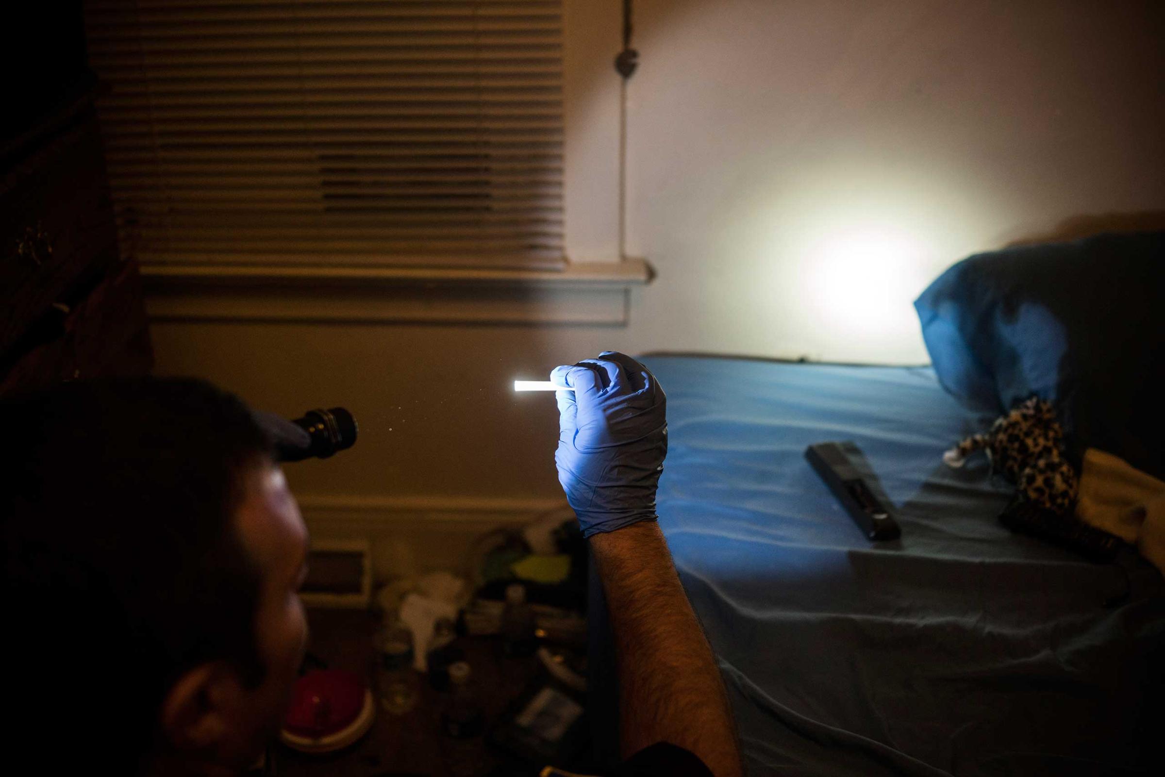 A police officer holds up drug paraphernalia after searching through a teenager’s room in East Liverpool, Ohio, on Oct. 8, 2016. The teen's mother called the police after her daughter vandalized her car and invited the officer into her home to search her daughter's room and take out whatever drugs he found. She said “Im tired of her using and I don’t know what to do about it. Just take it all.”