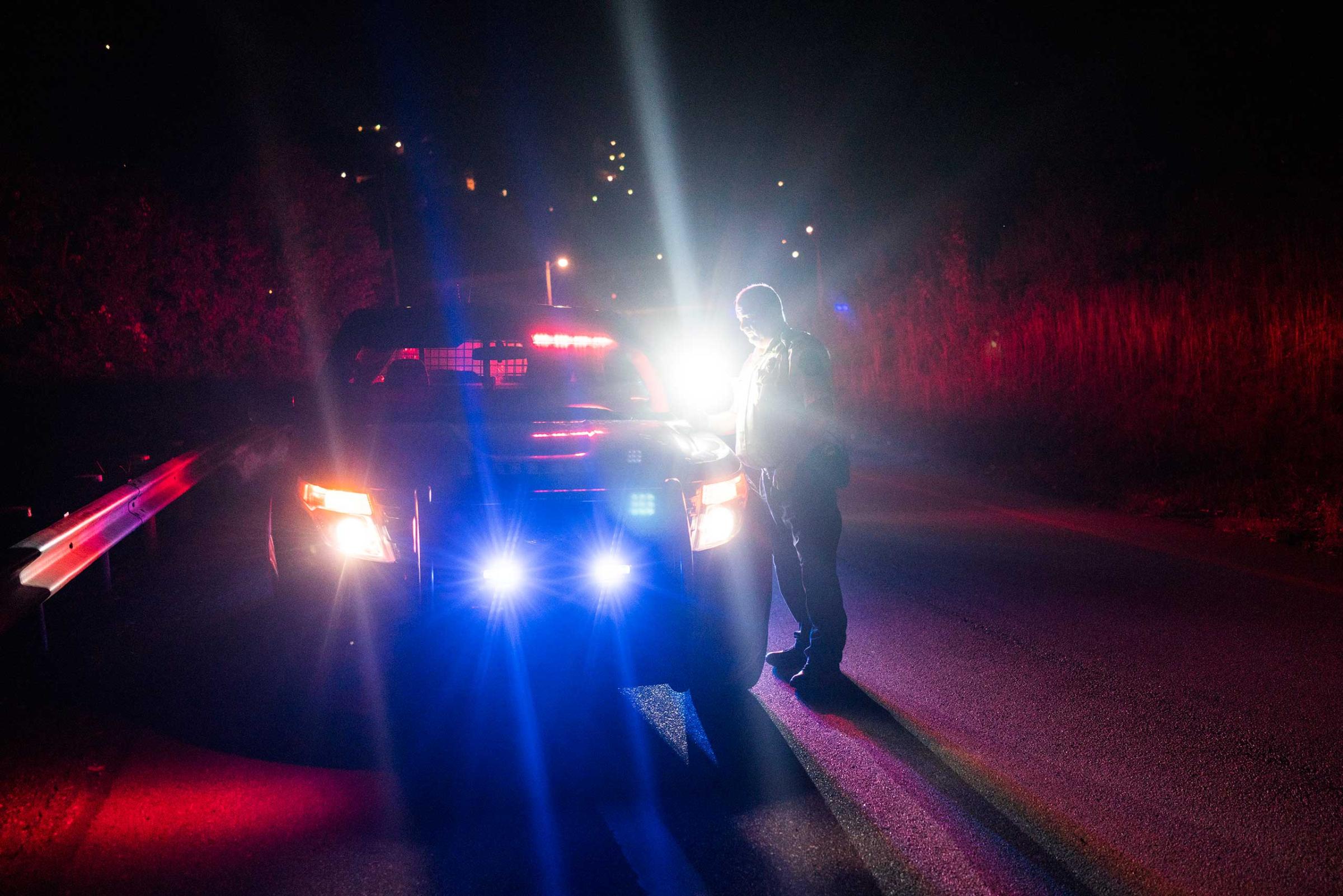 An East Liverpool police officer stands near his vehicle during a possible drug stop on the highway on Oct. 8, 2016. Police said many drug users have a Driver’s ID from one state and plates from another since East Liverpool is right on the border between Ohio, Pennsylvania and West Virginia. Drug offensives are much more severe in the latter, so many prefer to be caught and charged in Ohio.