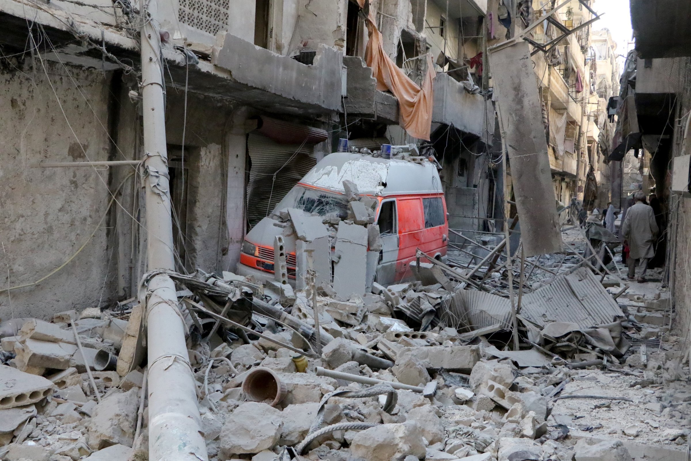 A wrecked ambulance is seen inside the debris of collapsed buildings after the Russian army hit the residential area with cluster bombs over opposition controlled Salihin neighborhood of Aleppo, Syria on Sept. 11, 2016.