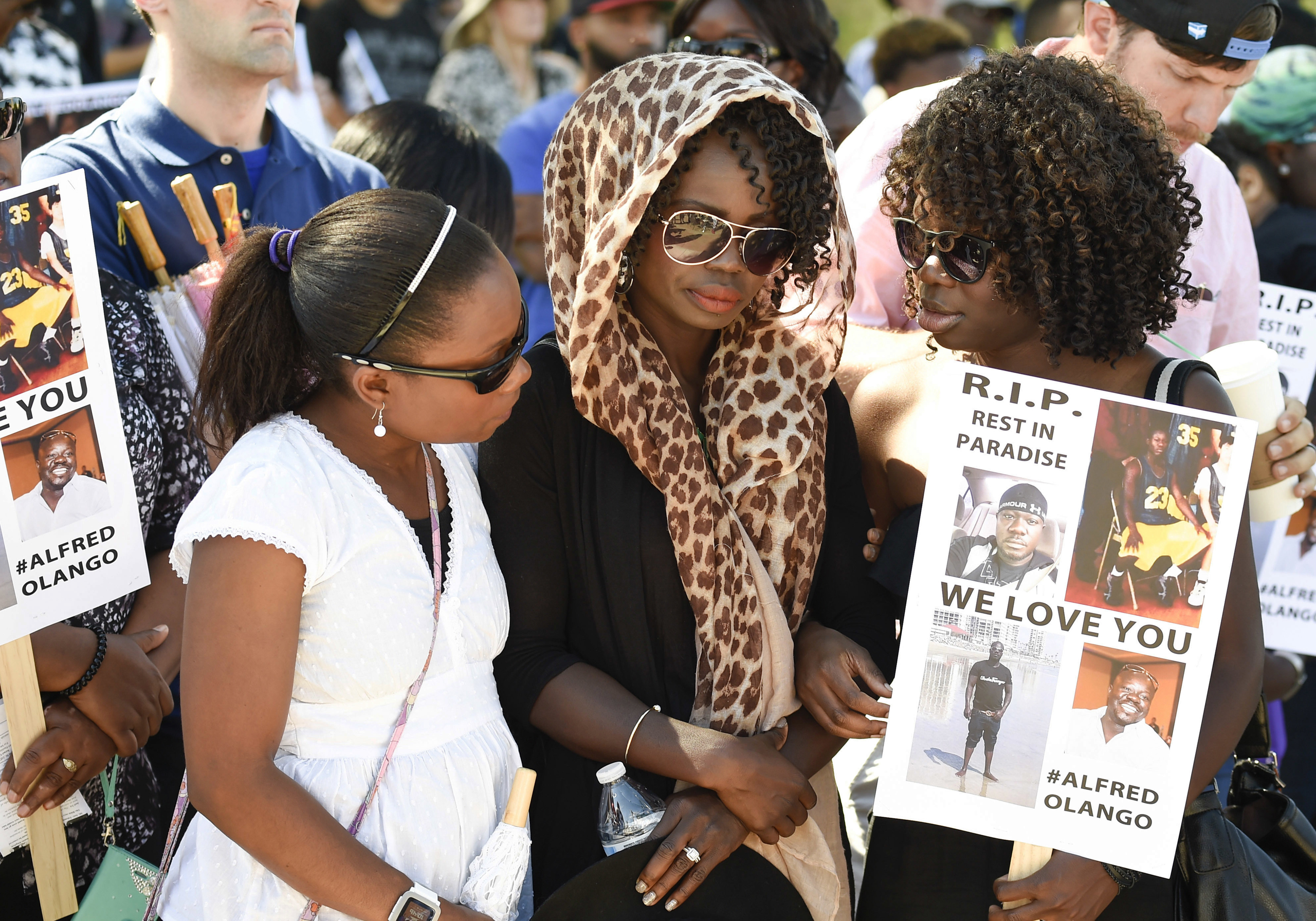 Winnie Olango, center, sister of Alfred Olango, is consoled by two friends before a march in reaction to the fatal police shooting of her brother, in El Cajon, Calif., on Oct. 1, 2016. (Denis Poroy—AP)
