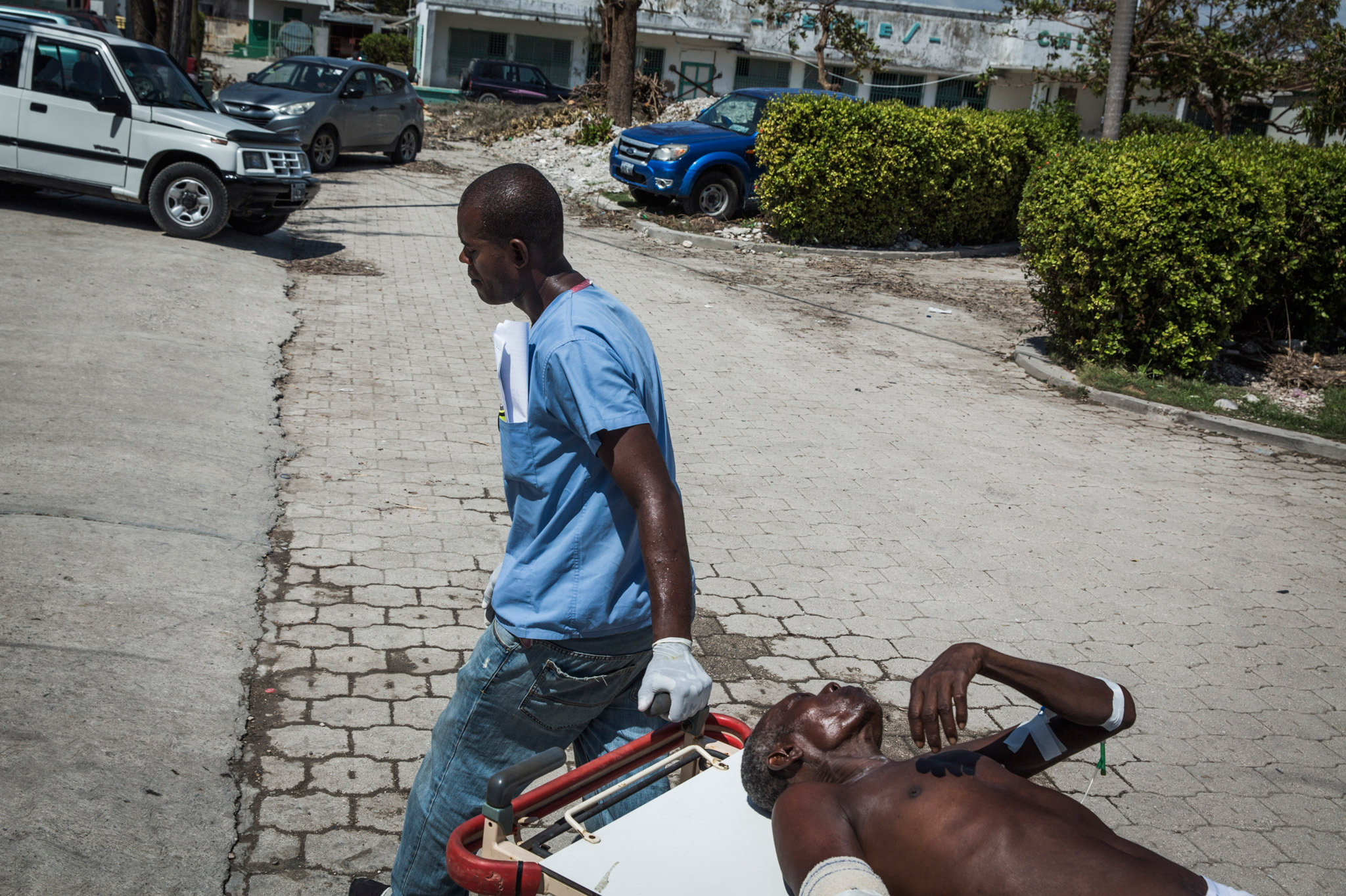 A woman who was severely injured during Hurricane Matthew is transferred between wards at the General Hospital in Les Cayes, Haiti, on Oct. 9, 2016.