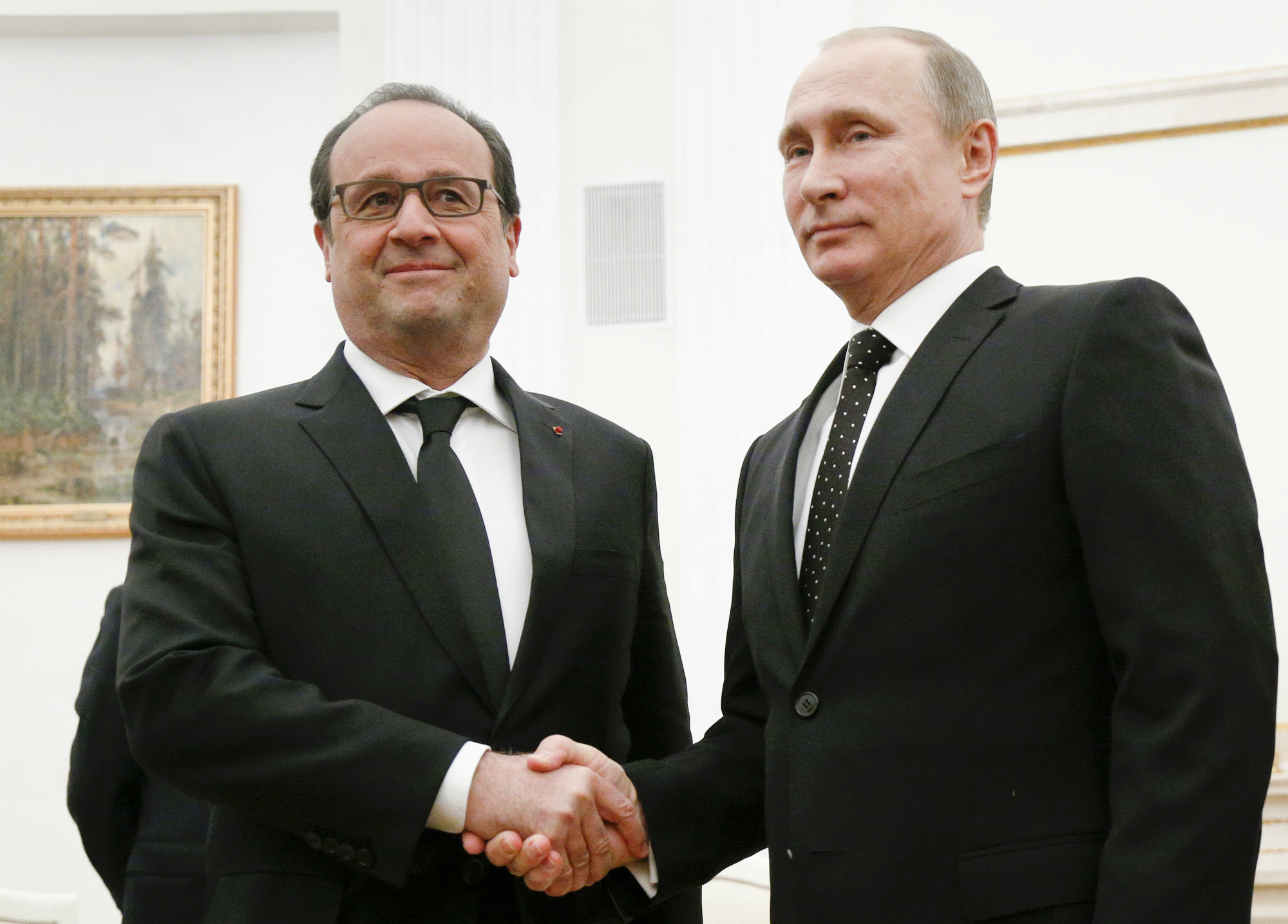 In this Thursday, Nov. 26, 2015 file photo, Russian President Vladimir Putin, right, shakes hands with his French counterpart Francois Hollande during their meeting in Moscow, Russia. (AP Photo/Alexander Zemlianichenko, Pool, File) (Alexander Zemlianichenko&mdash;AP)