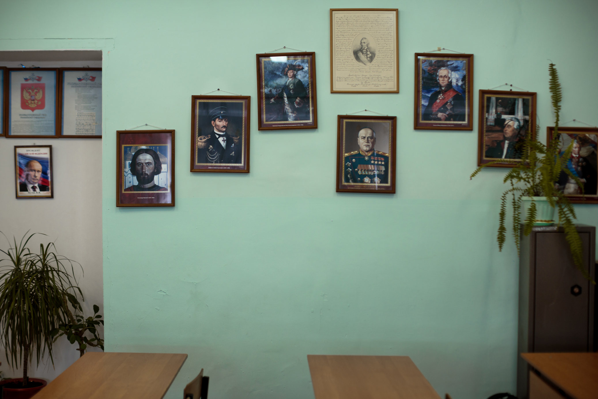 A classroom wall at School #7 decorated with legacies from Russian history, starting with Vladimir Putin on the far left.