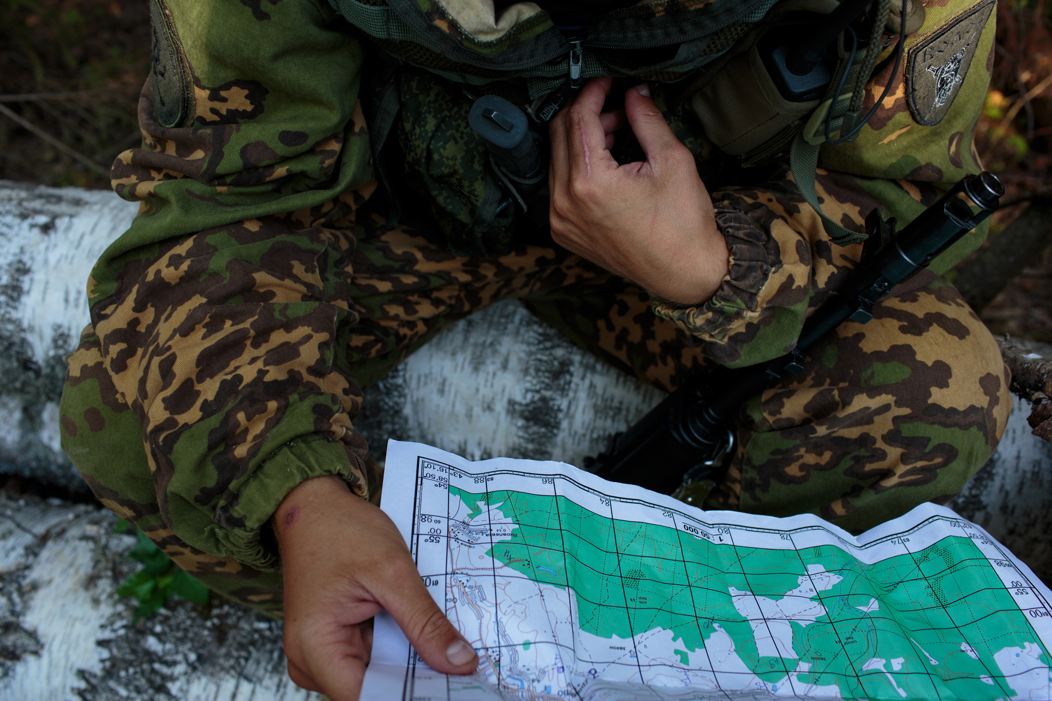 Evgeni (Jenya) Riabyxin, age 22, from Stavropol studies a map during a twelve-hour drill in the forests surrounding Diveevo, Russia.