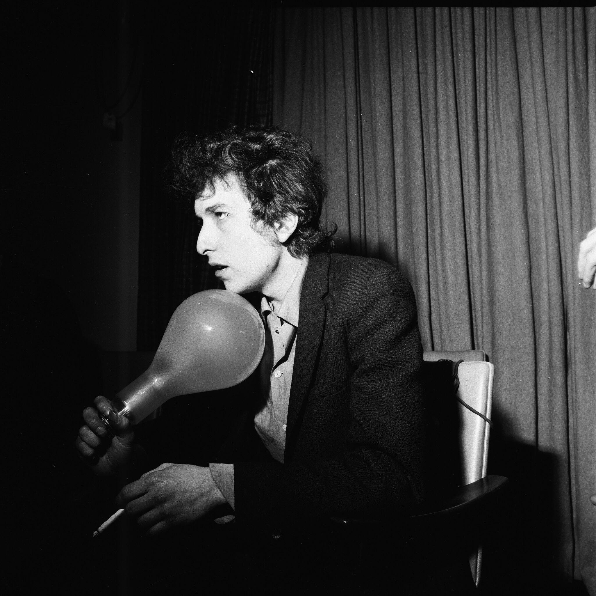 Bob Dylan holding a large light bulb at a press conference, London, 1965. (Stanley Bielecki/ASP—Getty Images)