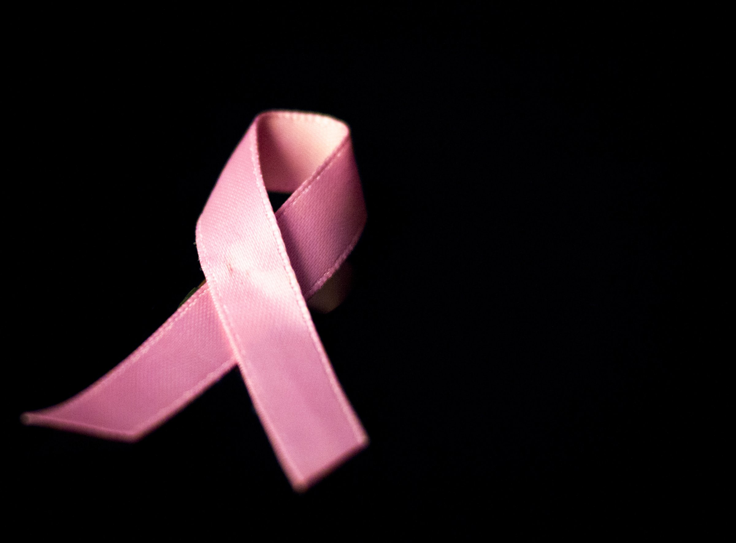 Pink breast cancer ribbon bow symbol