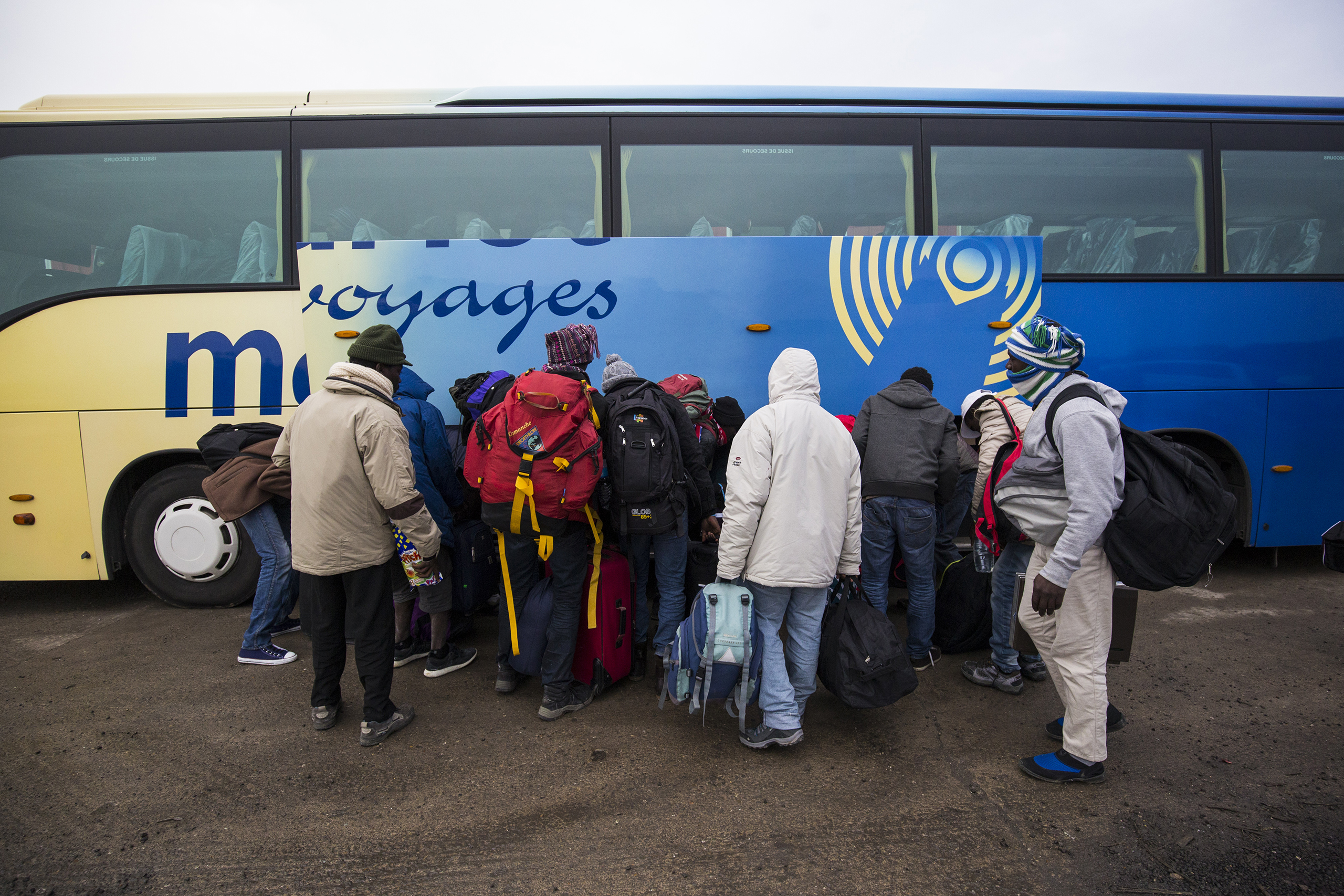 Migrants board buses outside the  Jungle  migrant camp dismantled this week by authorities, headed to refugee centers around France, at a reception point in Calais on Oct. 24, 2016.