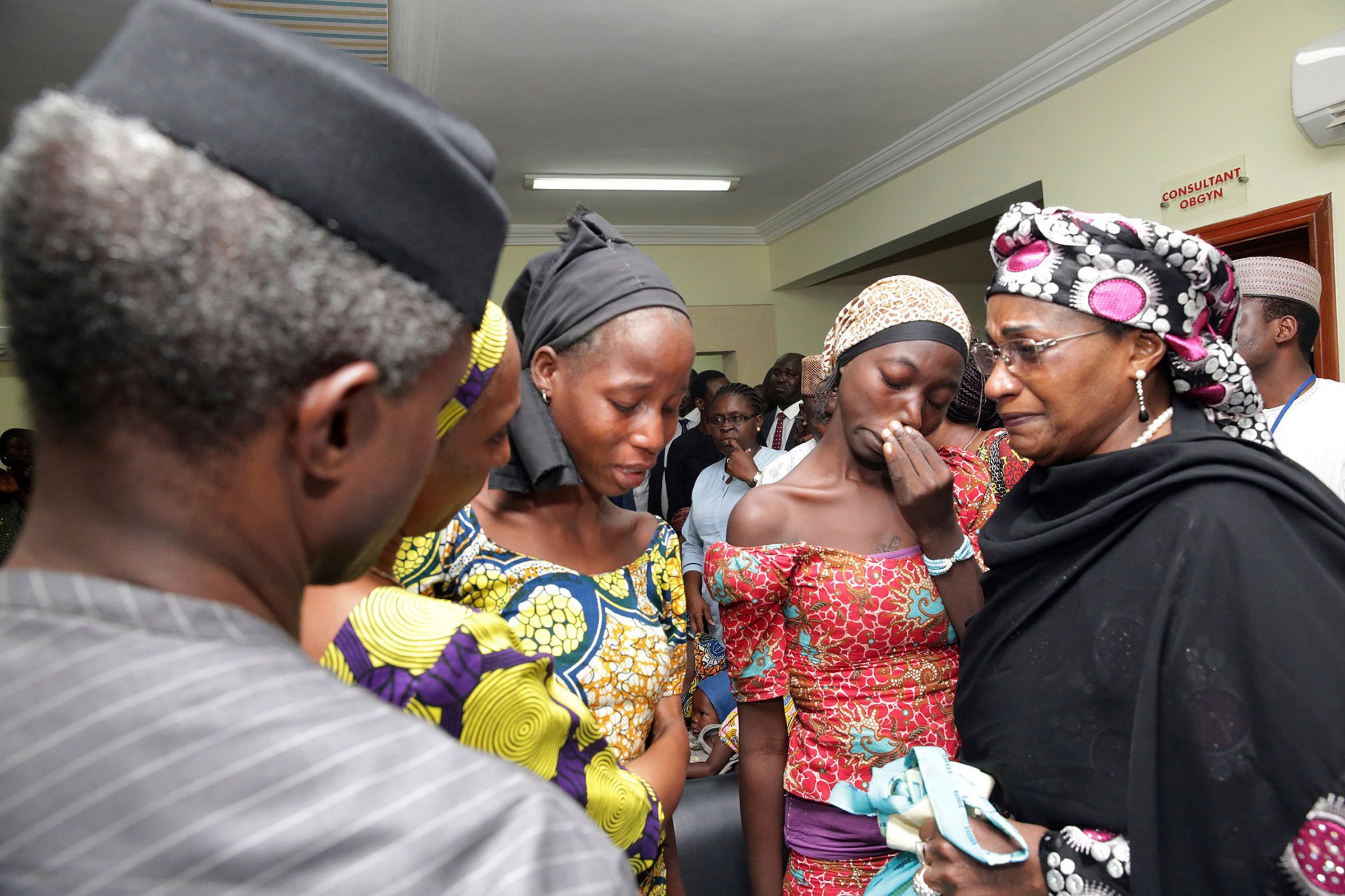 In this photo released by the Nigeria State House, Nigeria's Vice President Yemi Osinbajo, left, welcomes some of the freed Chibok school girls at the state House in Abuja, Nigeria, Thursday, Oct. 13, 2016. Twenty-one of the Chibok schoolgirls kidnapped by Boko Haram more than two years ago were freed Thursday in a swap for detained leaders of the Islamic extremist group ‚Äî the first release since nearly 300 girls were taken captive in a case that provoked international outrage. (Sunday Aghaeze/Nigeria State House via AP)